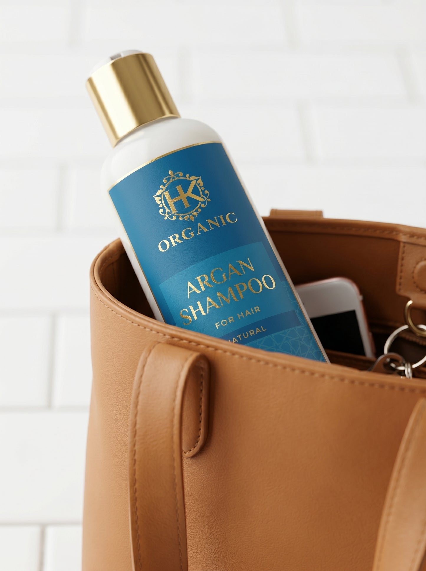 Organic argan shampoo bottle in a brown leather bag with a white background