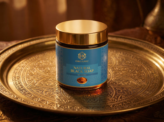 Jar of natural black soap on a decorative gold tray