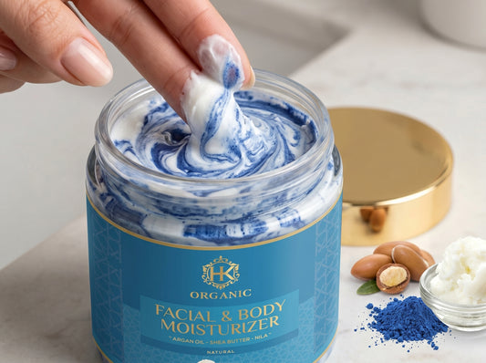 Hand scooping moisturizer from a jar labeled 'Organic Facial & Body Moisturizer' with ingredients visible in the background.