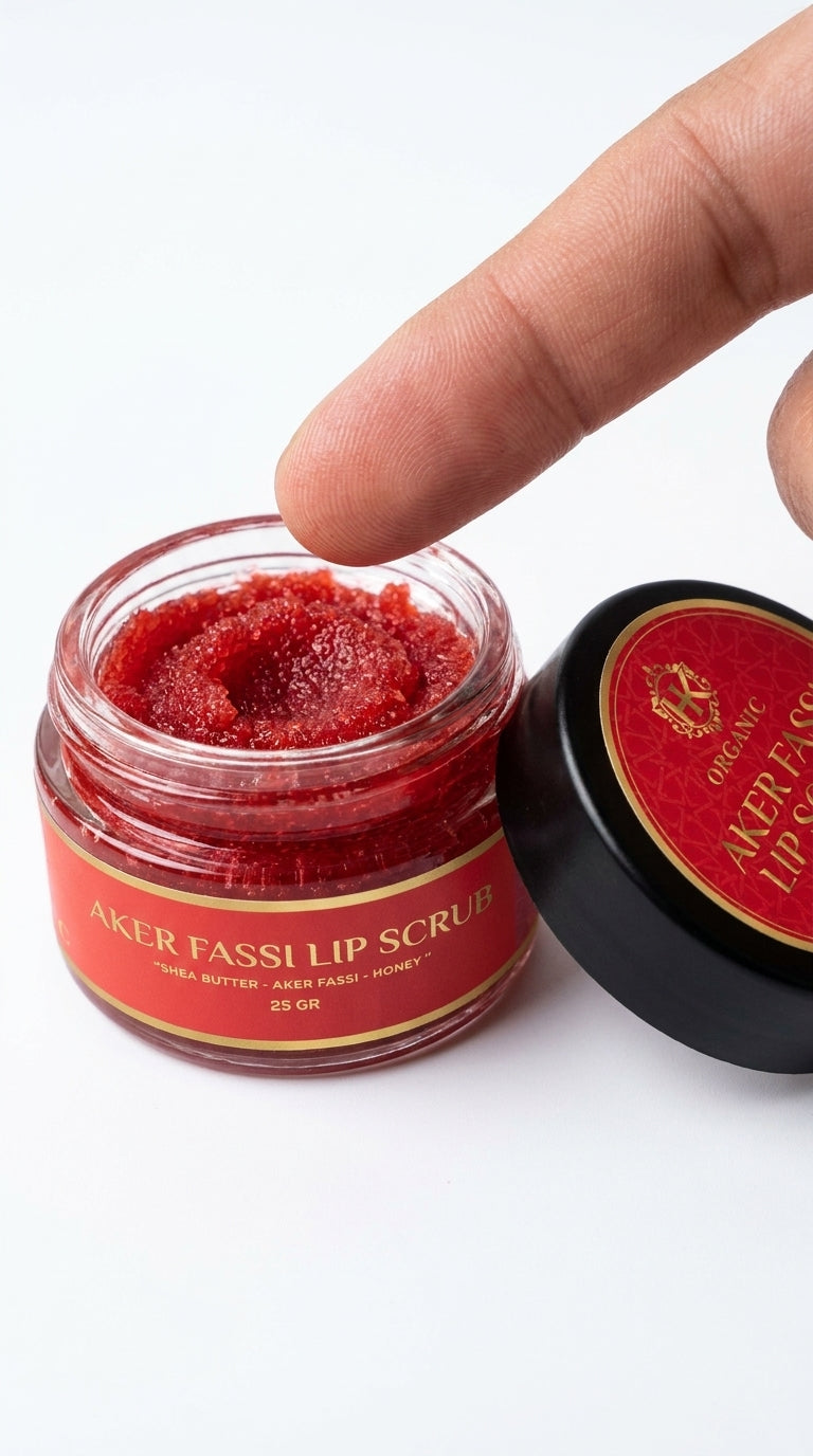 Lip scrub jar with red substance and a hand holding the lid on a white background