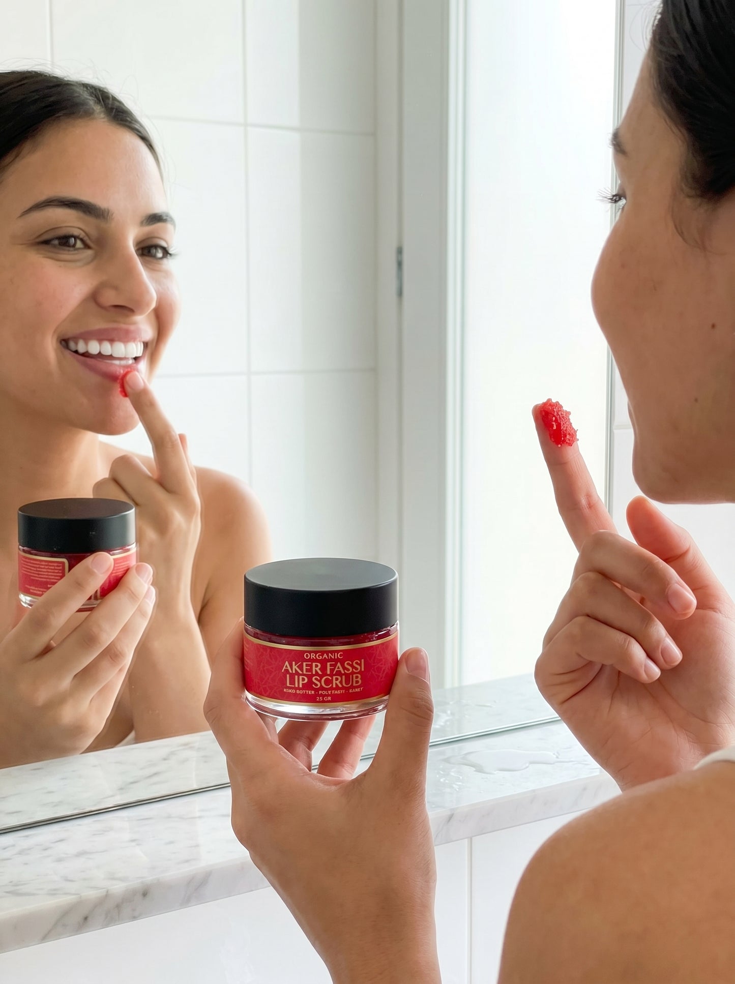 Woman applying lip scrub from Aker Fassi jar in front of a mirror.