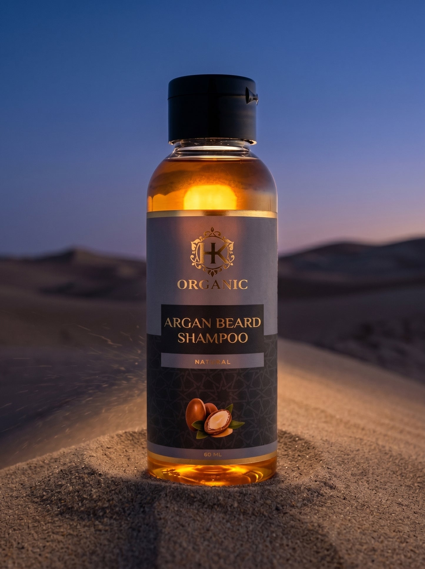 Bottle of Organic Argan Beard Shampoo on sand with a desert background