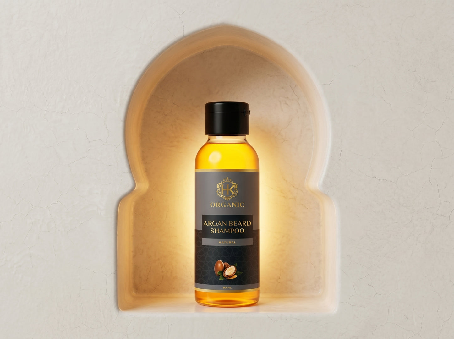 Bottle of argan beard shampoo in a decorative arch on a light background