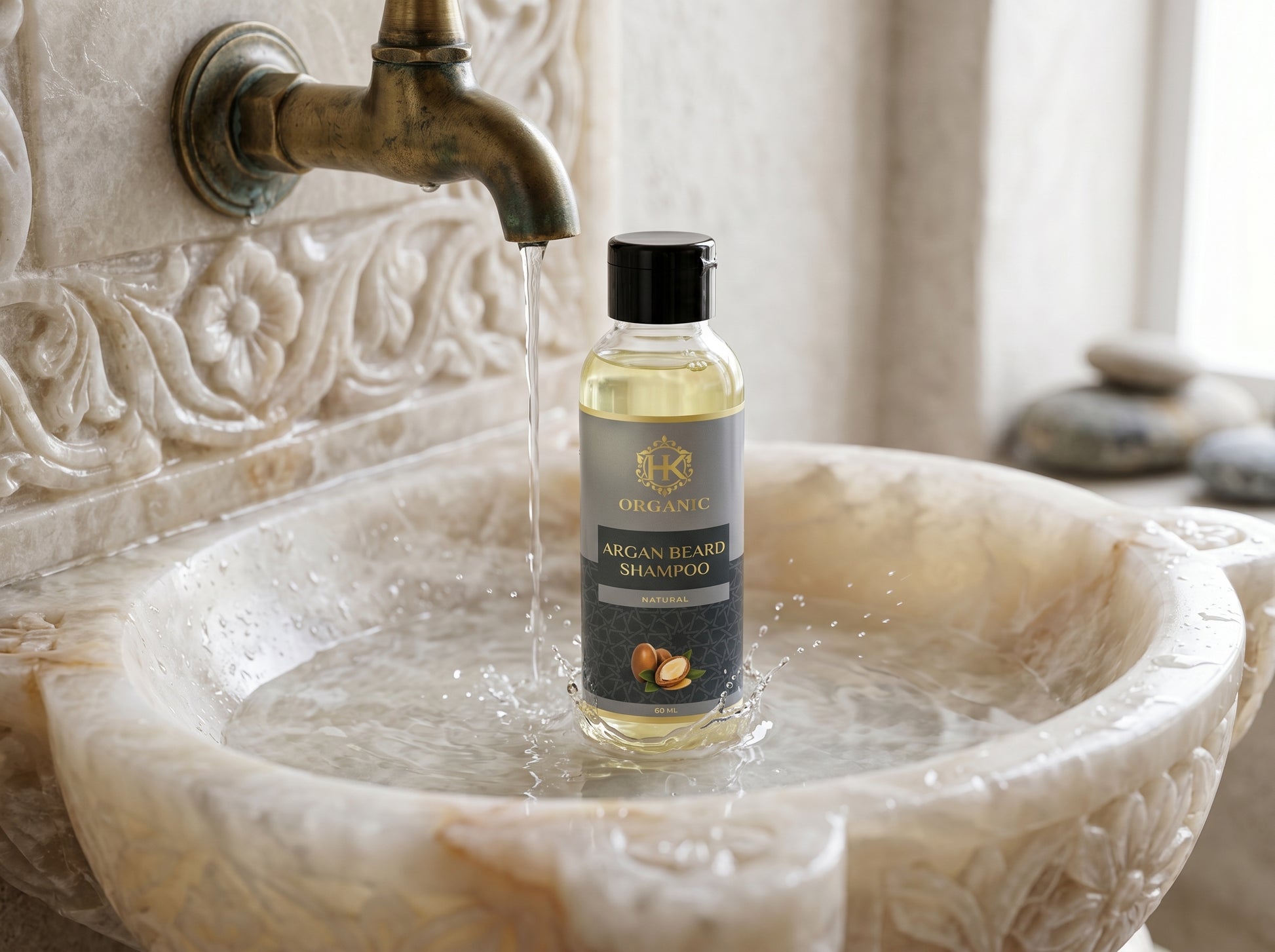 Bottle of Orlane Argan Beard Shampoo in a marble sink with water flowing.