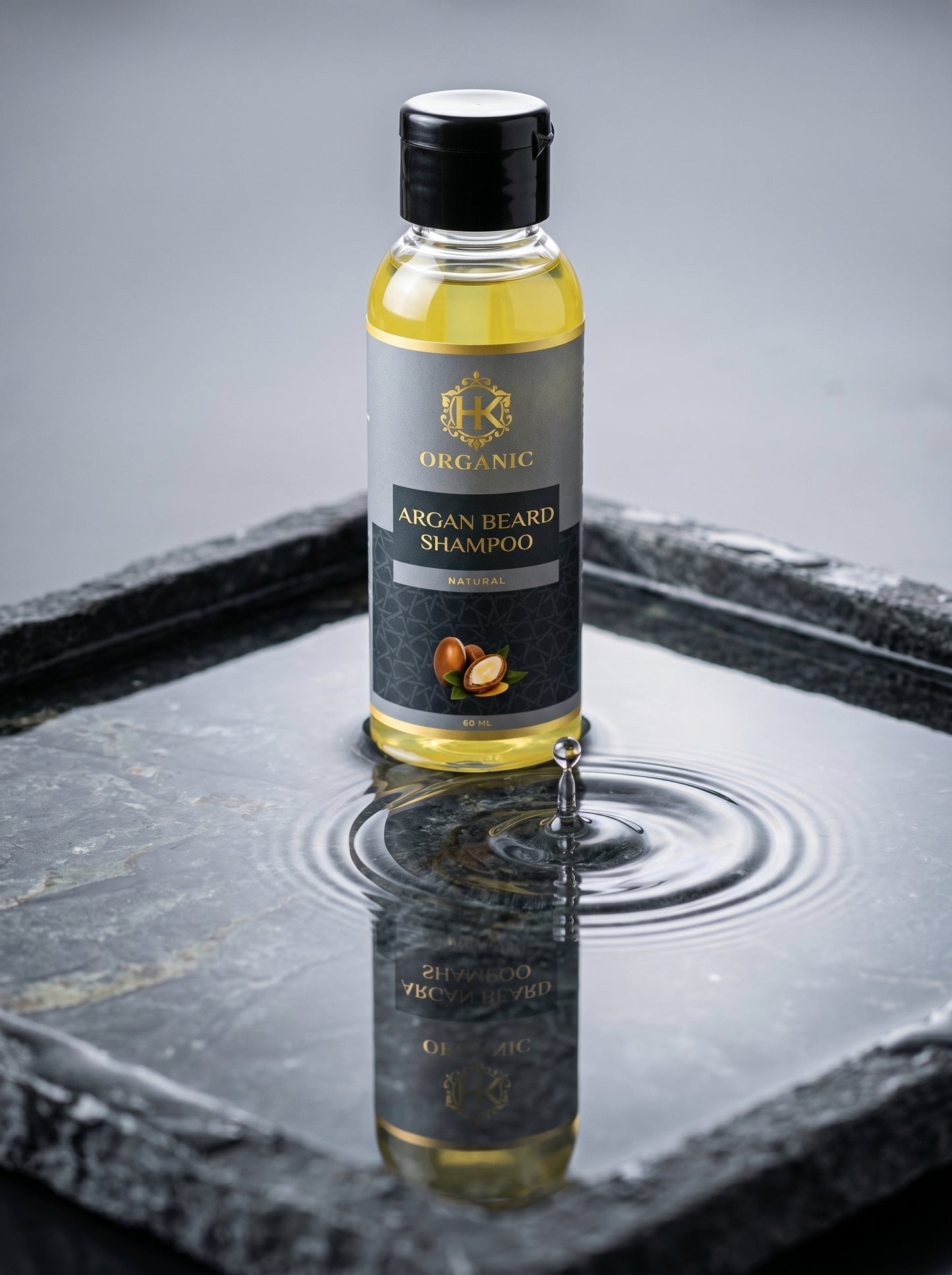 Bottle of Organic Argan Beard Shampoo on a reflective surface with a gray background