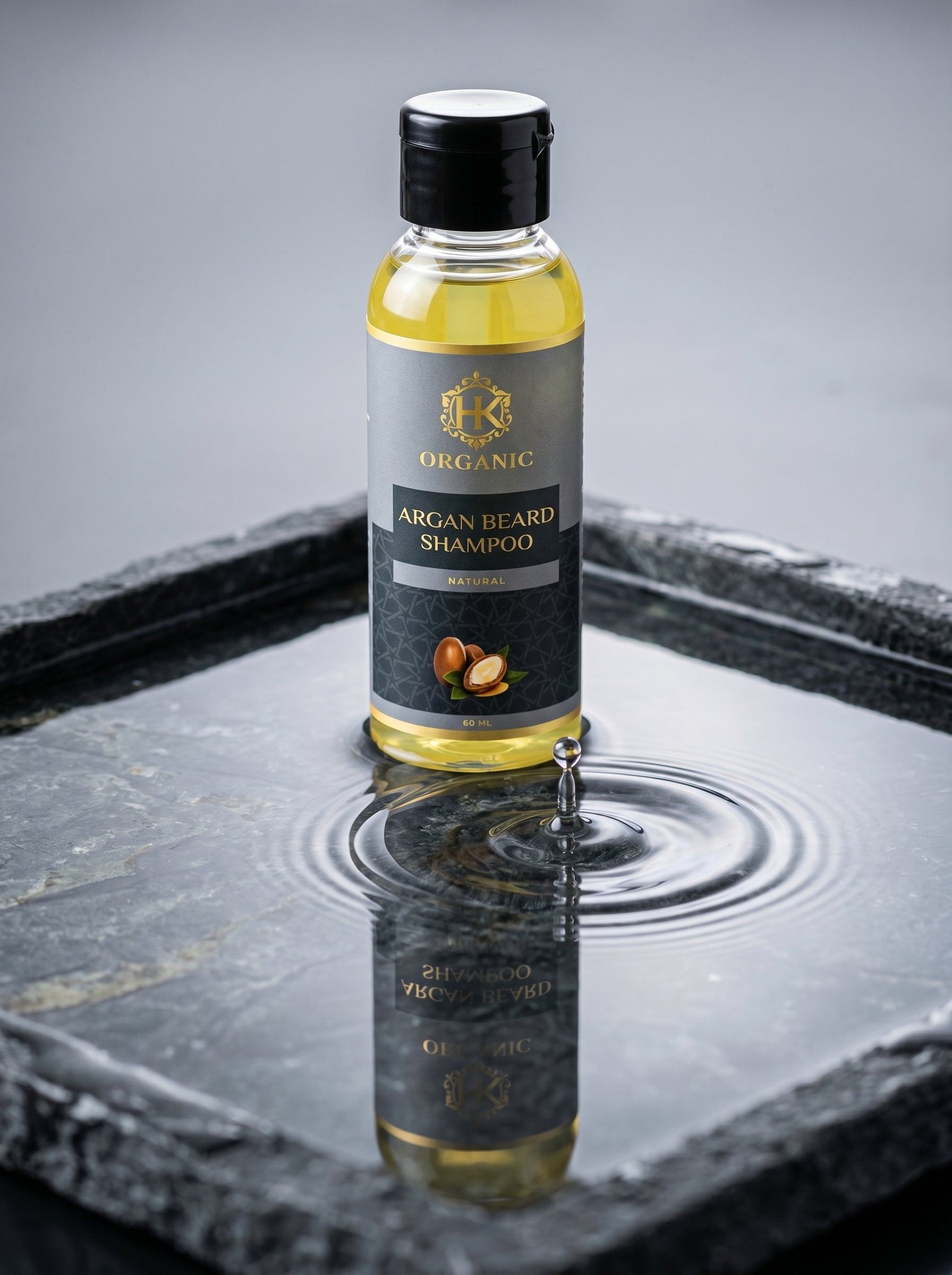 Bottle of Organic Argan Beard Shampoo on a reflective surface with a gray background