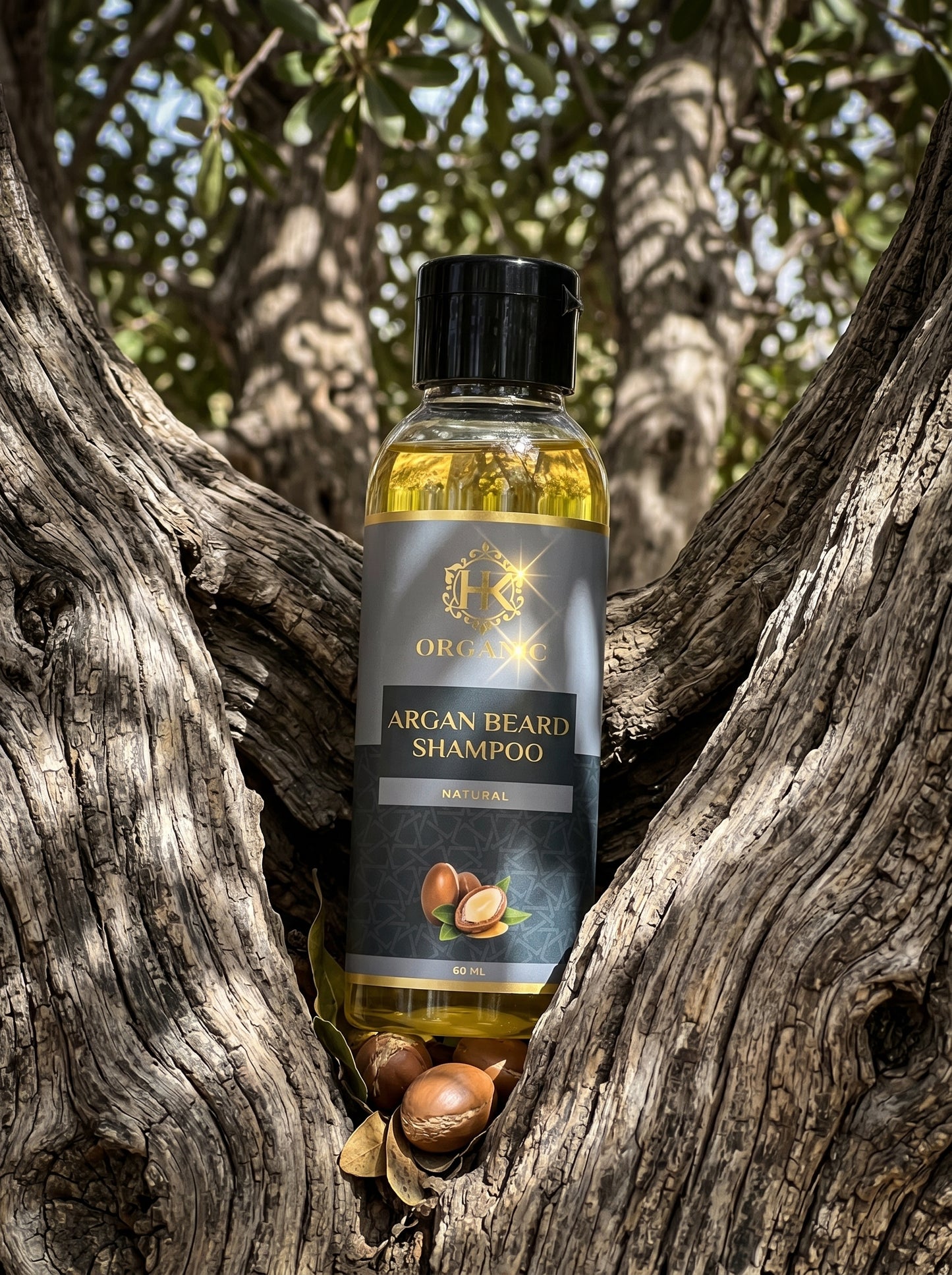 Bottle of Argan Beard Shampoo surrounded by argan nuts in a natural setting