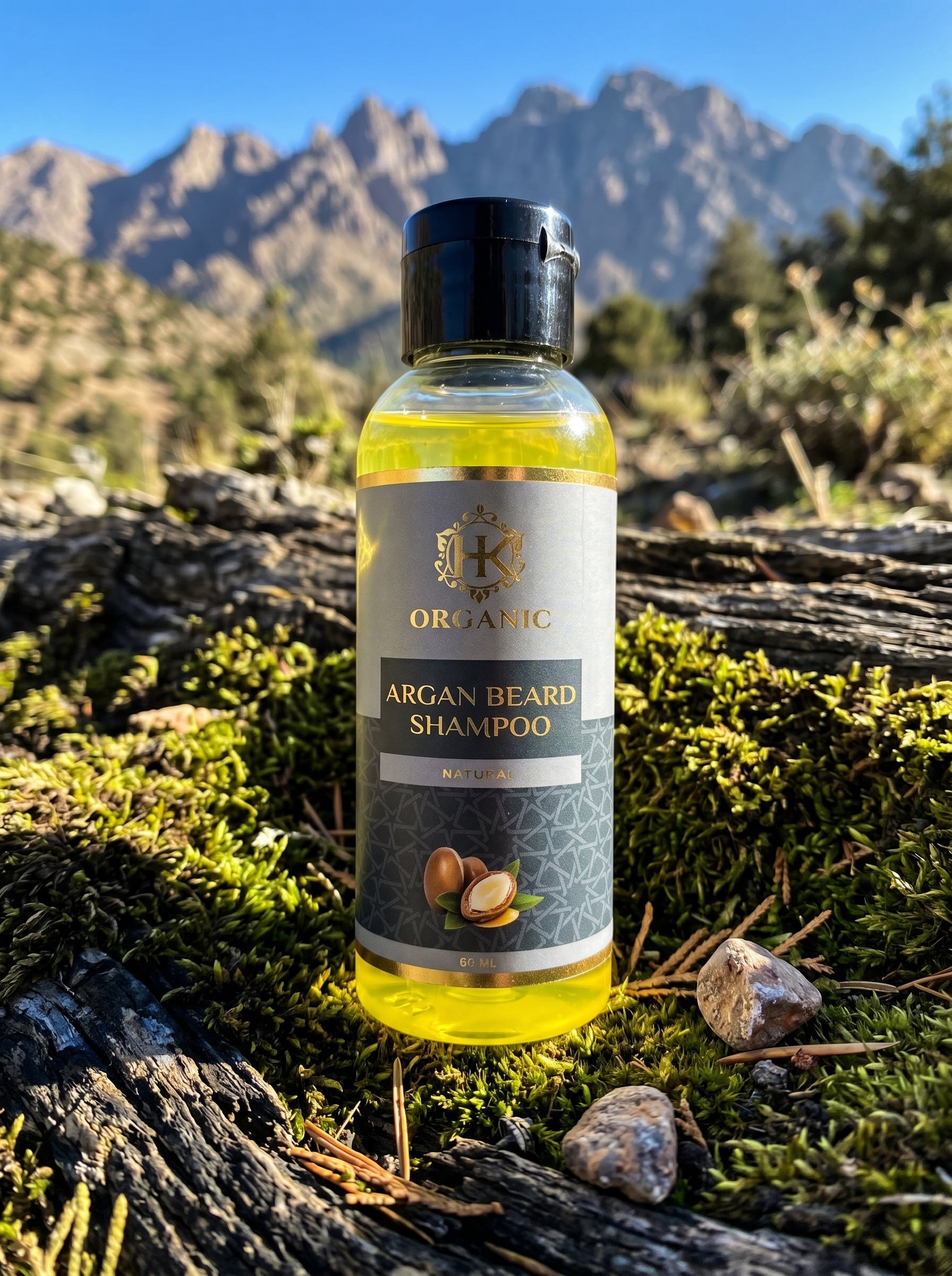 Bottle of Organic Argan Beard Shampoo on a log with mountains in the background