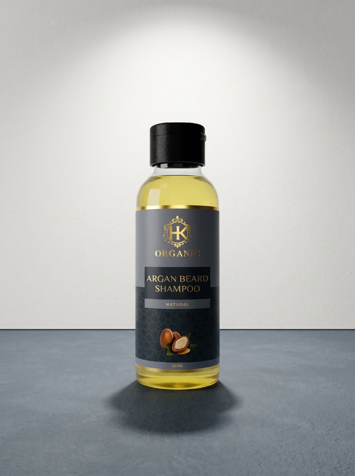 Bottle of argan beard shampoo with a black label on a gray surface.