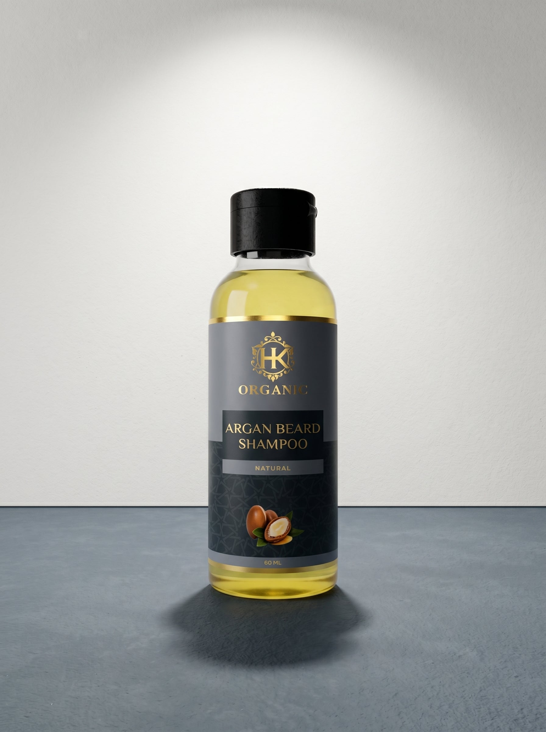 Bottle of argan beard shampoo with a black label on a gray surface.