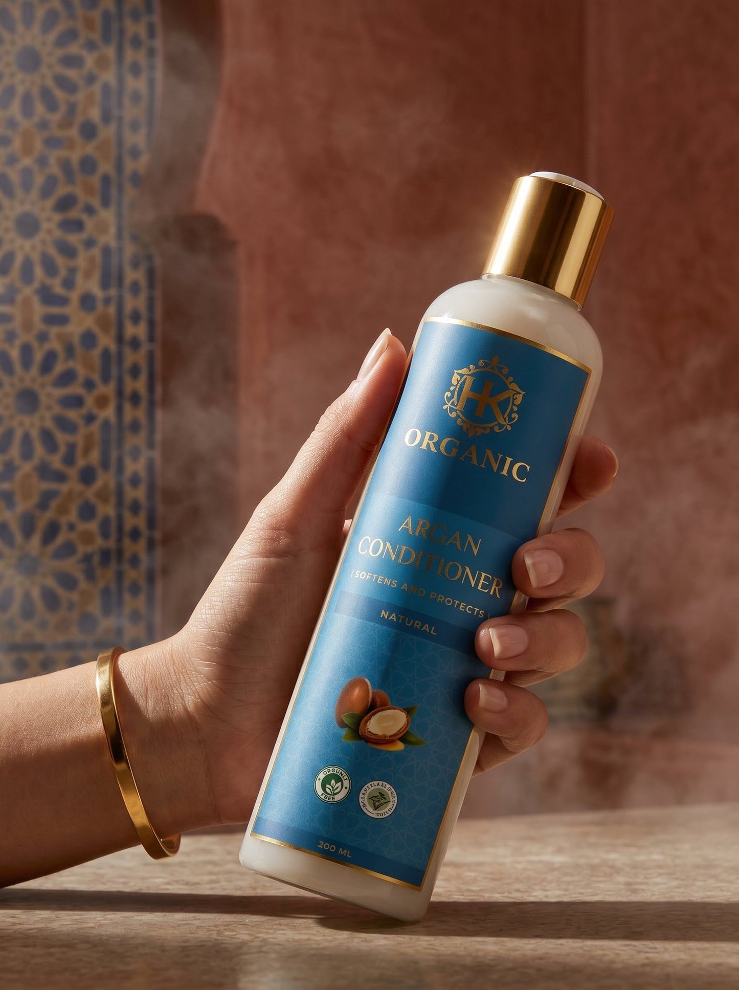 Hand holding a bottle of 'ORGANIC' air van conditioner on a wooden surface with a blurred background.