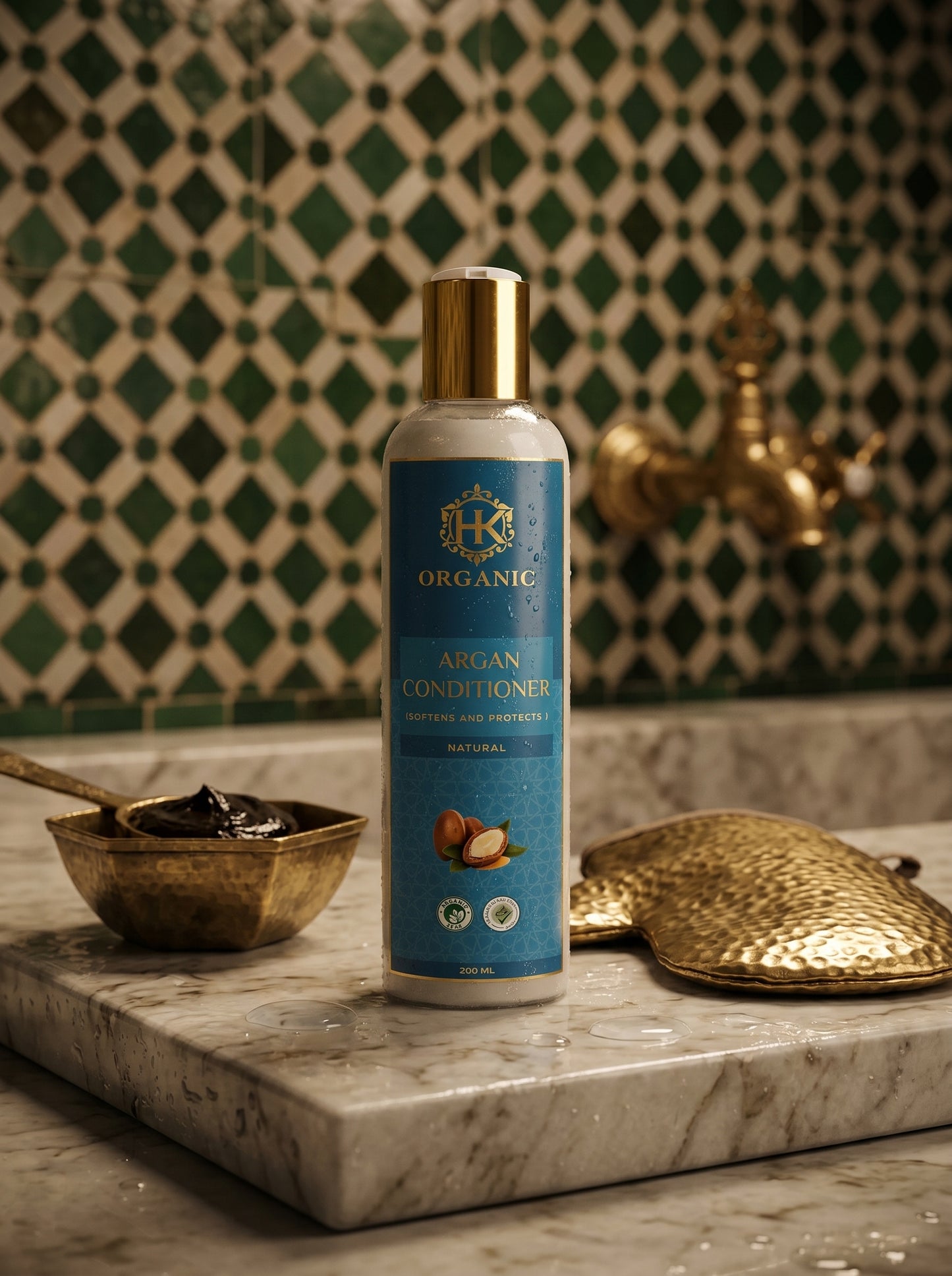 Bottle of organic argan conditioner on a marble surface with decorative elements in the background.