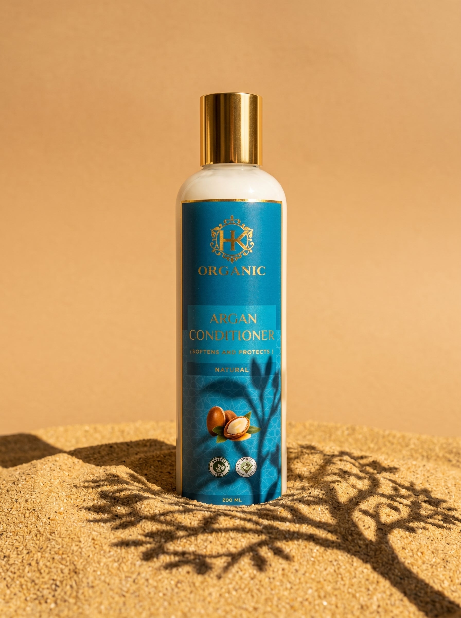 Bottle of Argan Conditioner with a gold cap on a beige background