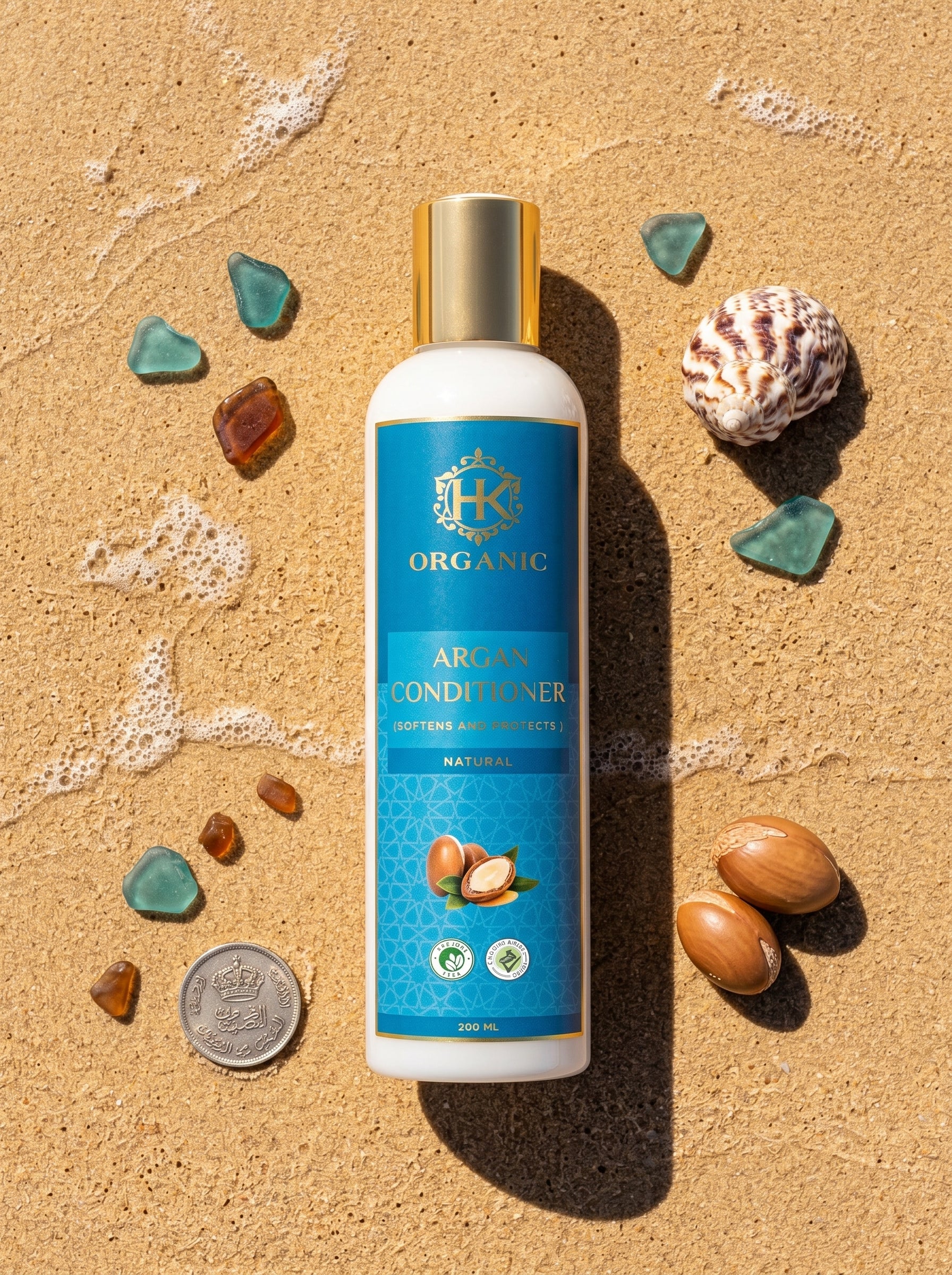 Argan conditioner bottle on sand with natural elements