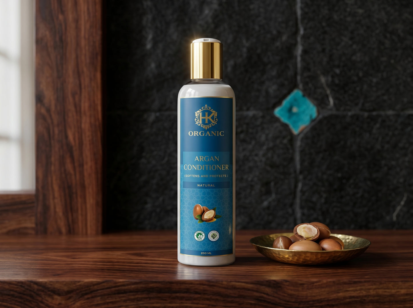 Bottle of organic argan conditioner on a wooden surface with argan nuts.