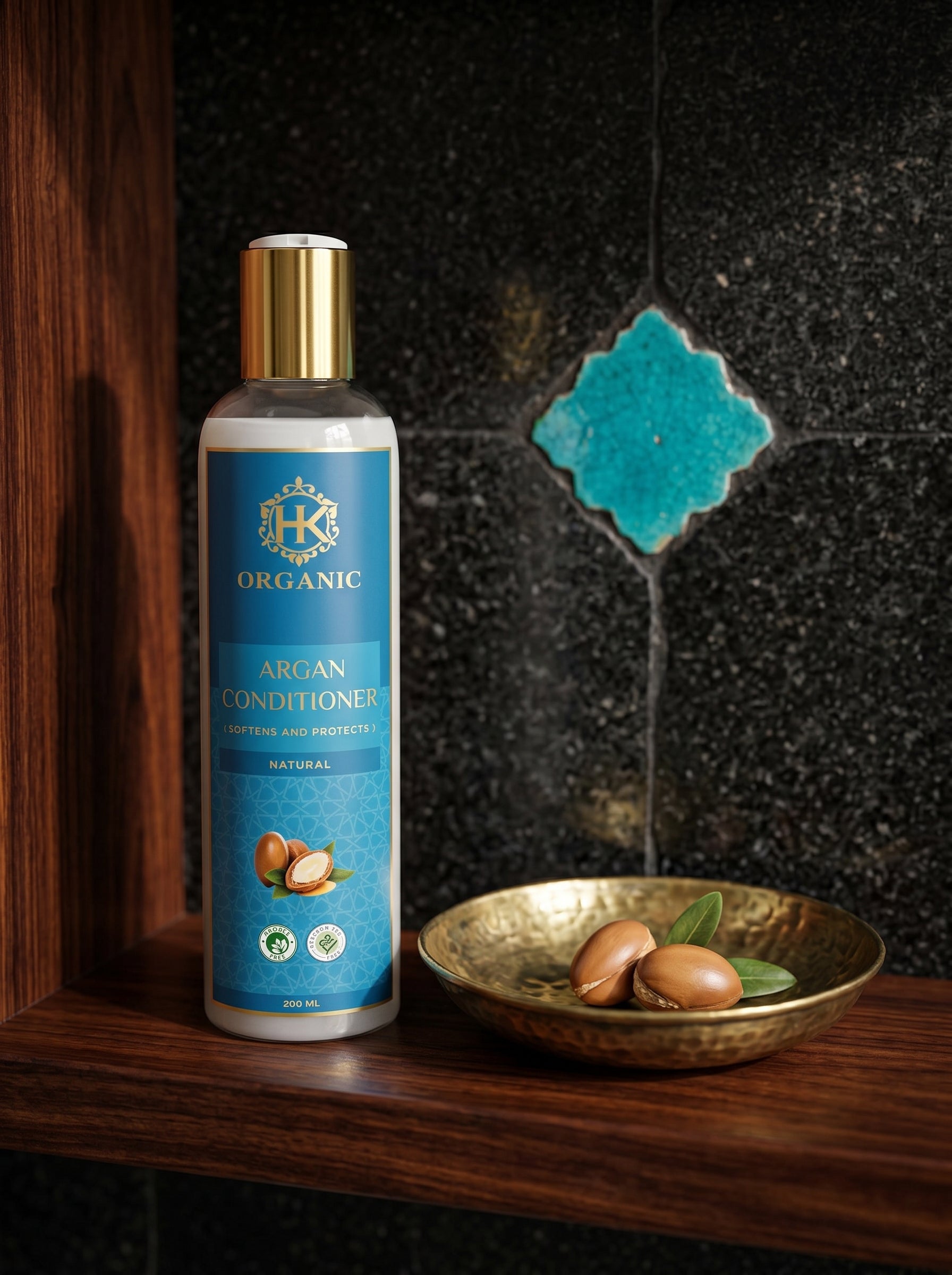 HK Organic Argan Conditioner bottle on a wooden shelf with a decorative bowl and argan nuts.