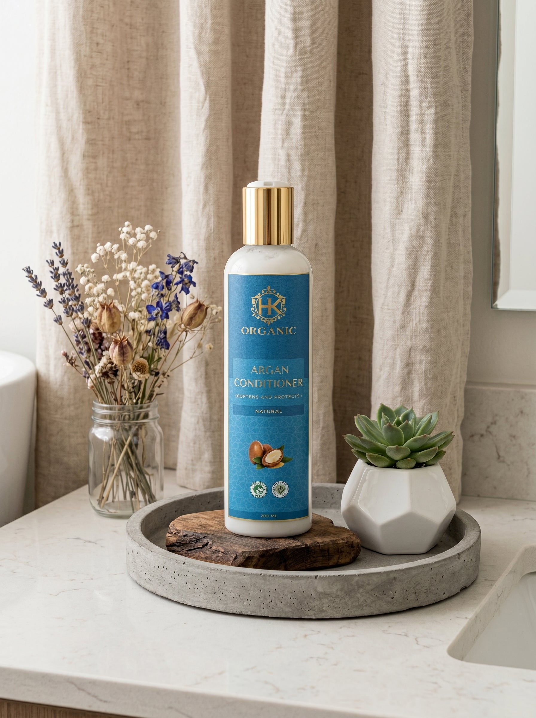Bottle of Argan Conditioner on a tray with decorative elements in a bathroom setting