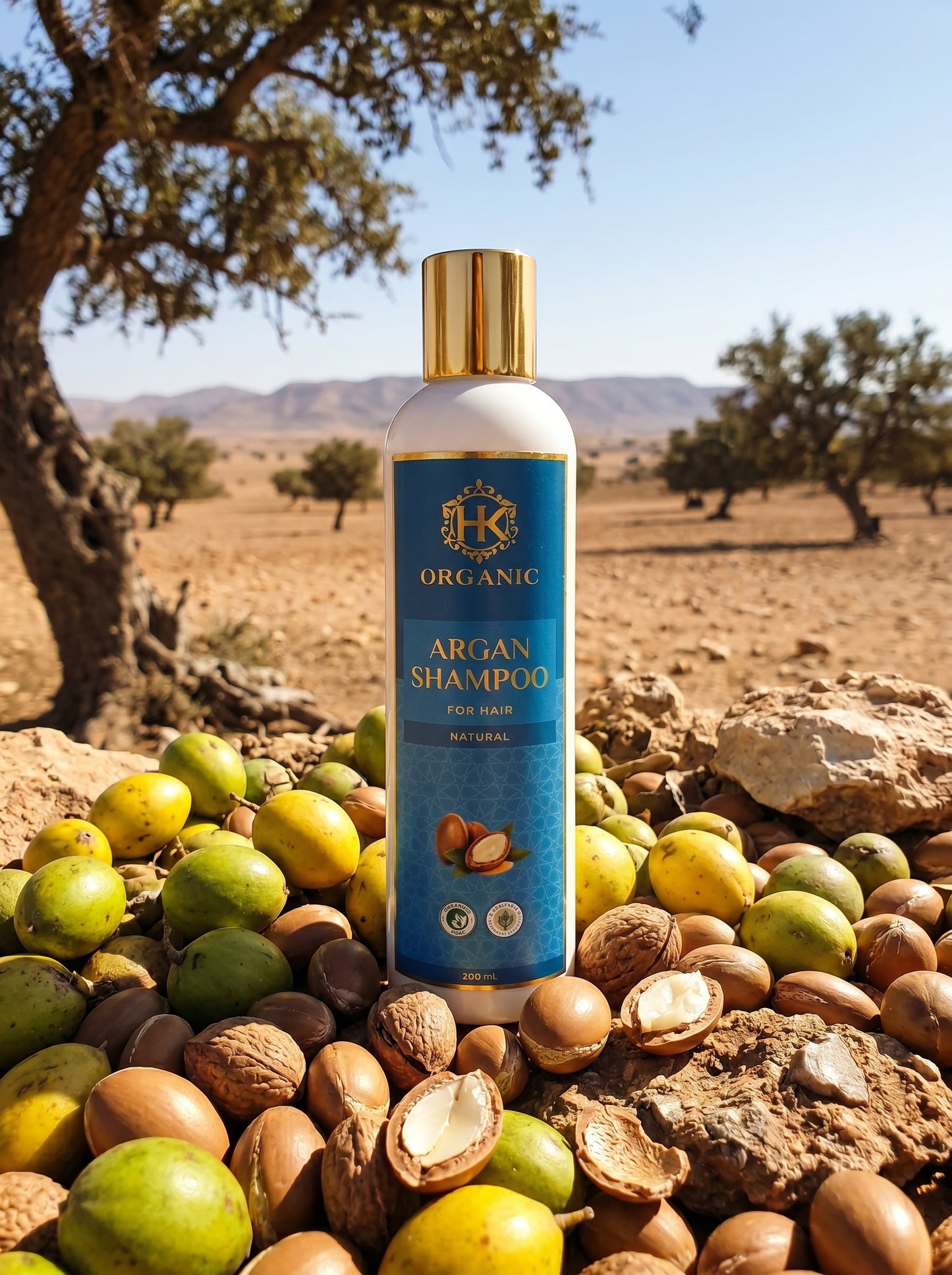 Argan shampoo bottle with argan fruits and nuts in a desert setting