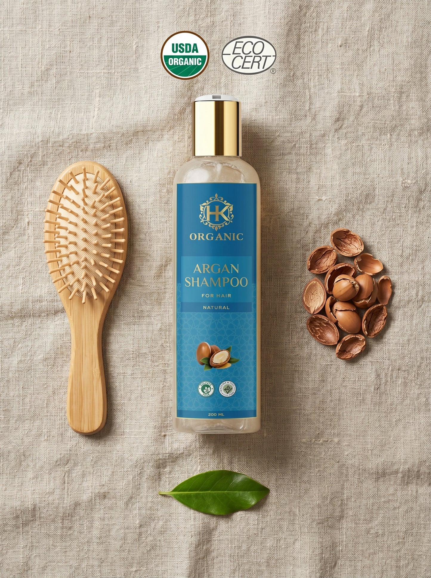 Organic argan shampoo bottle with a brush and nuts on a textured surface