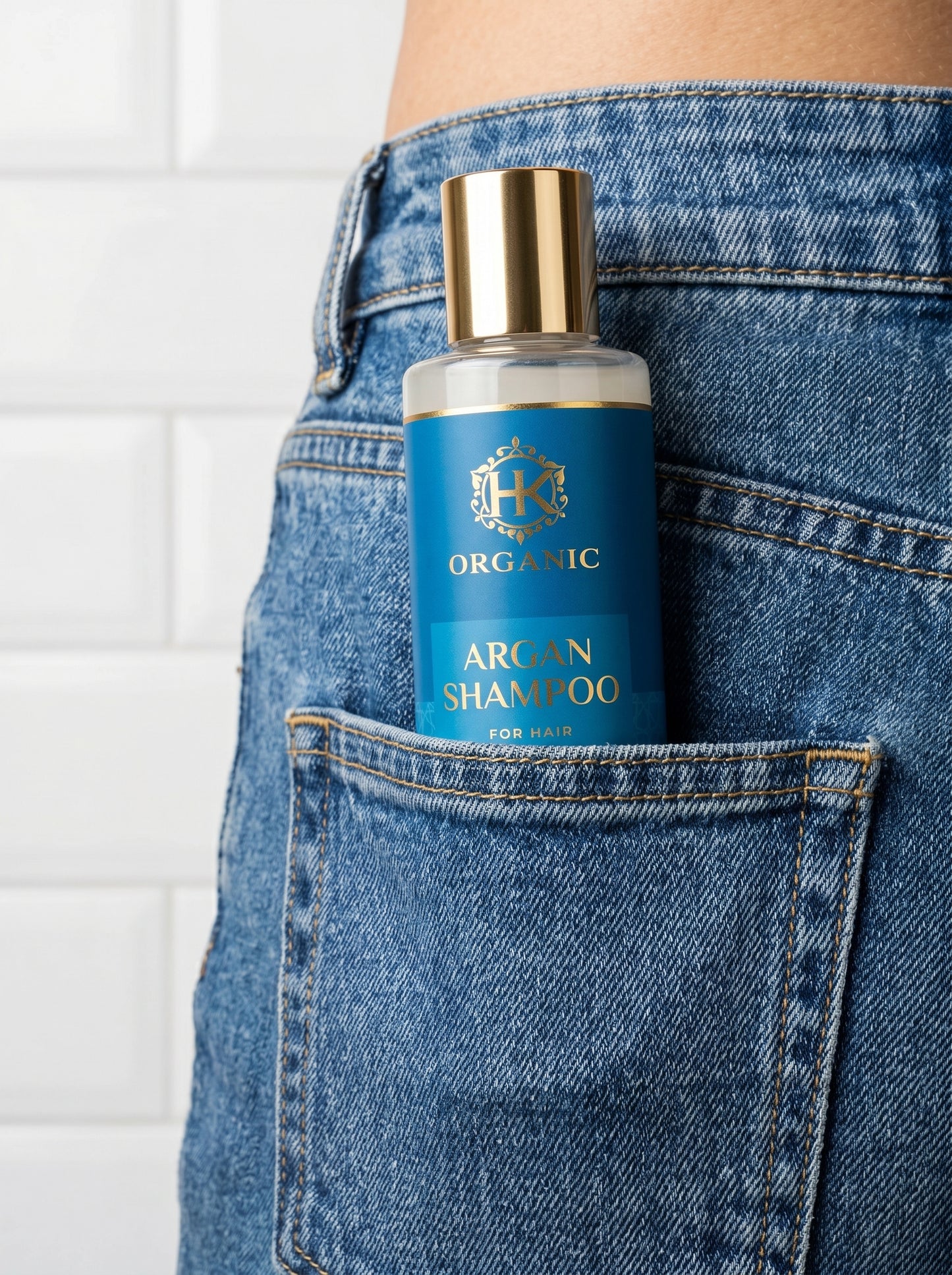 Bottle of Organic Argan Shampoo in a pocket with denim jeans