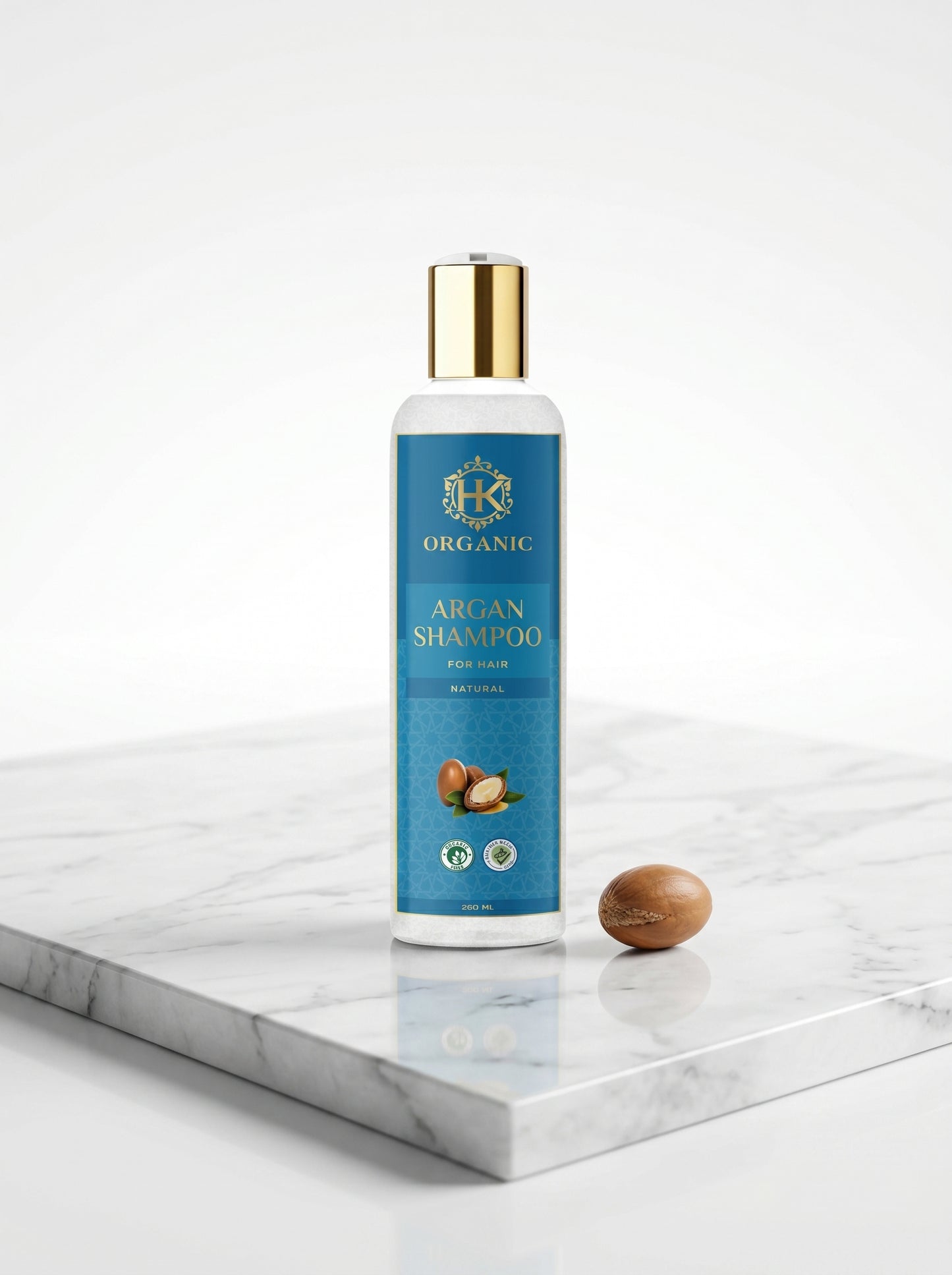 Bottle of Organic Argan Shampoo on a marble surface with a white background