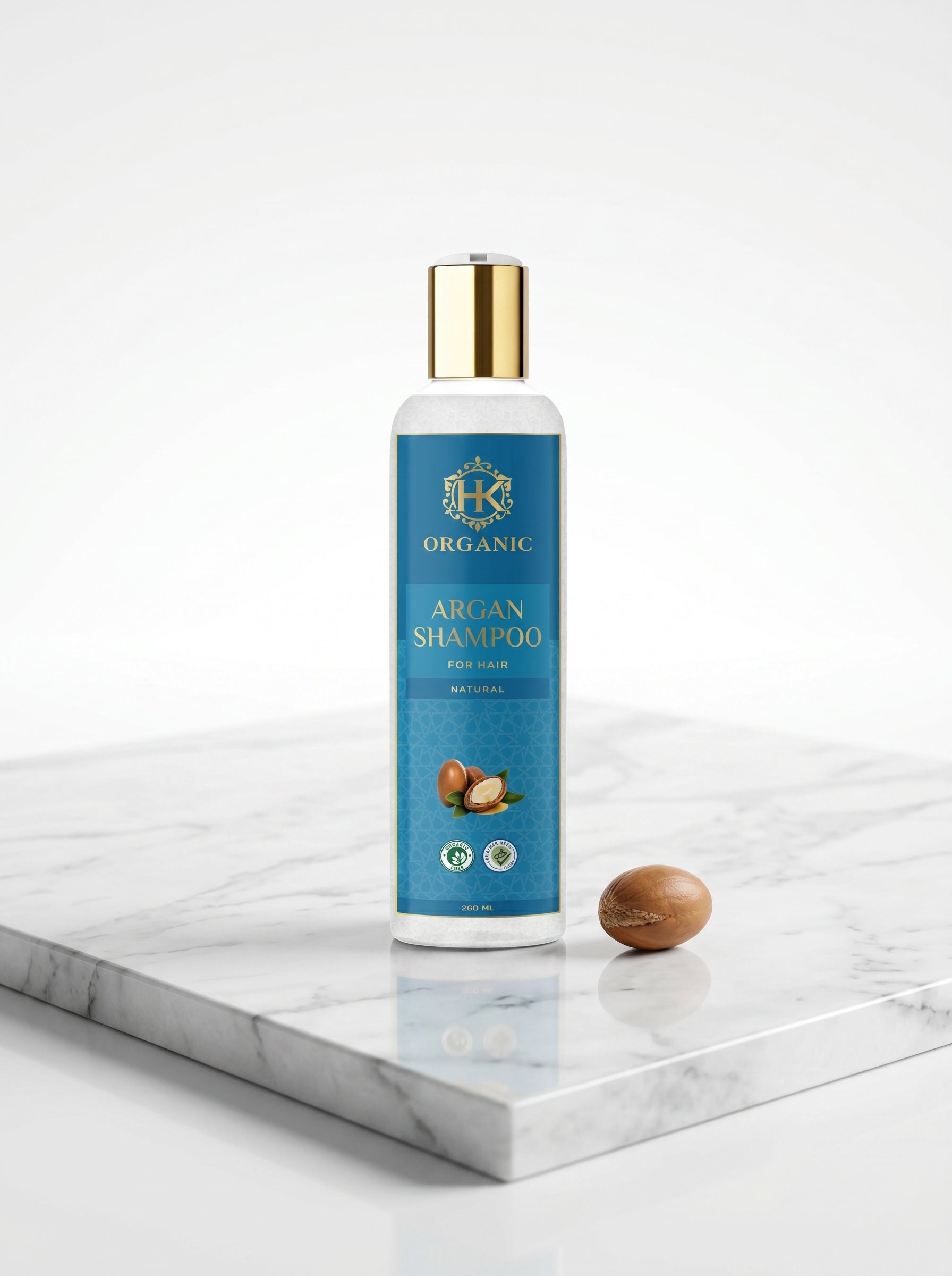 Bottle of Organic Argan Shampoo on a marble surface with a white background