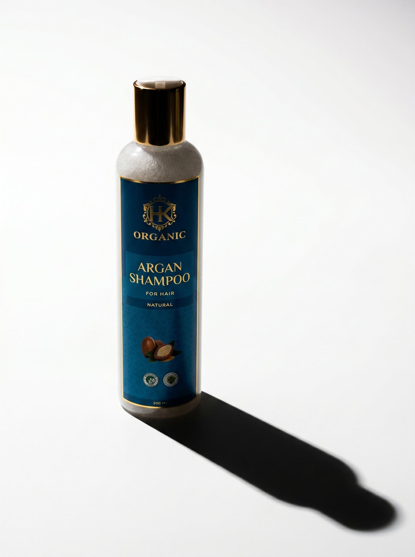 Bottle of organic argan shampoo on a white background