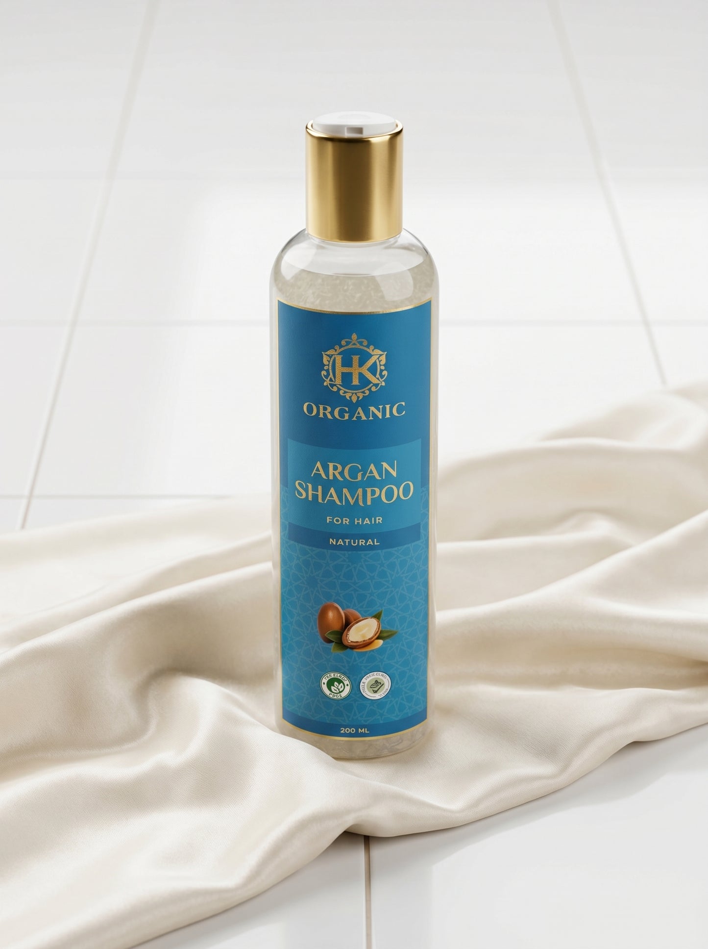 Bottle of organic argan shampoo on a white fabric background