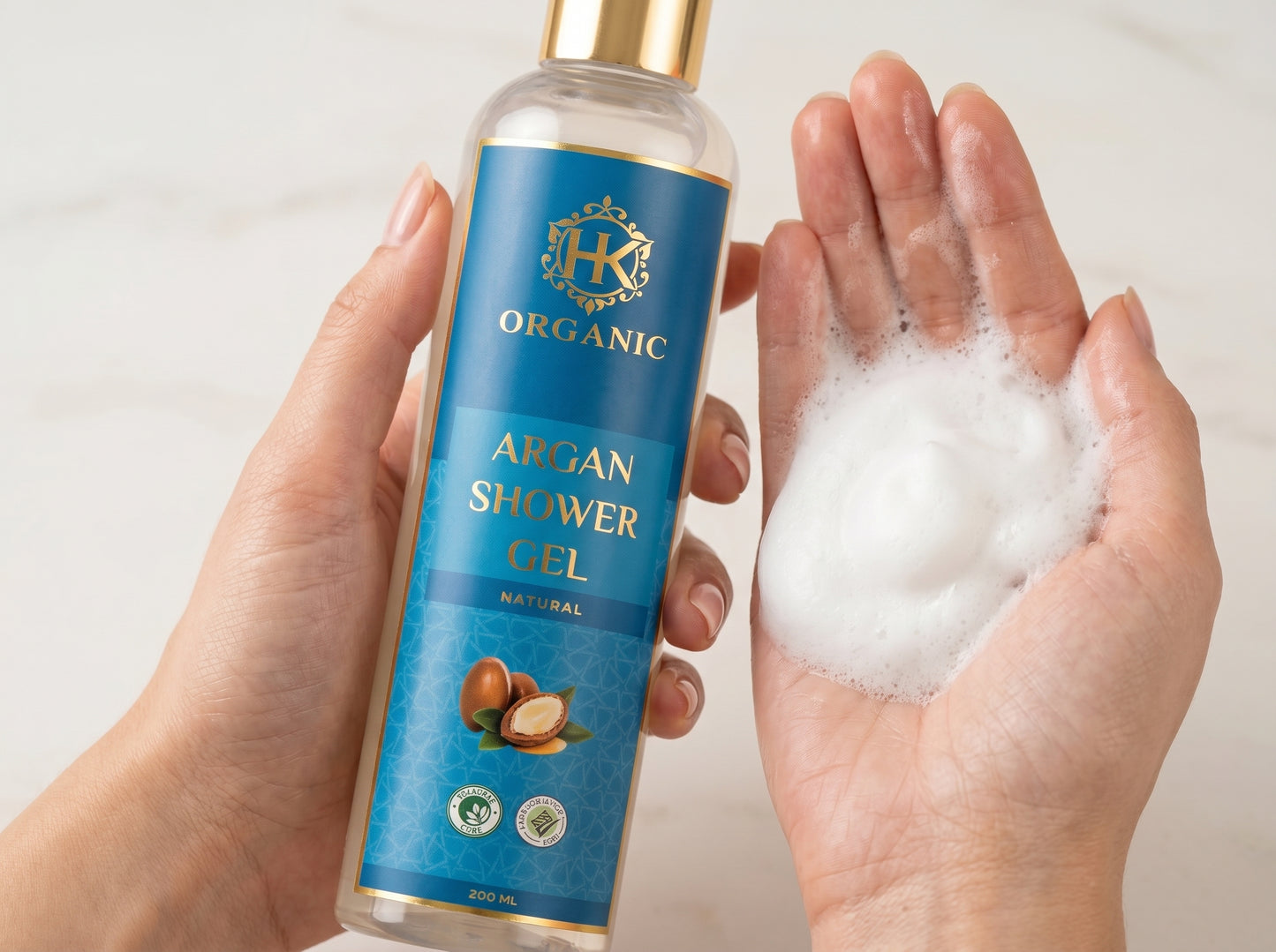 Bottle of Organic Argan Shower Gel with a hand holding some of the gel.