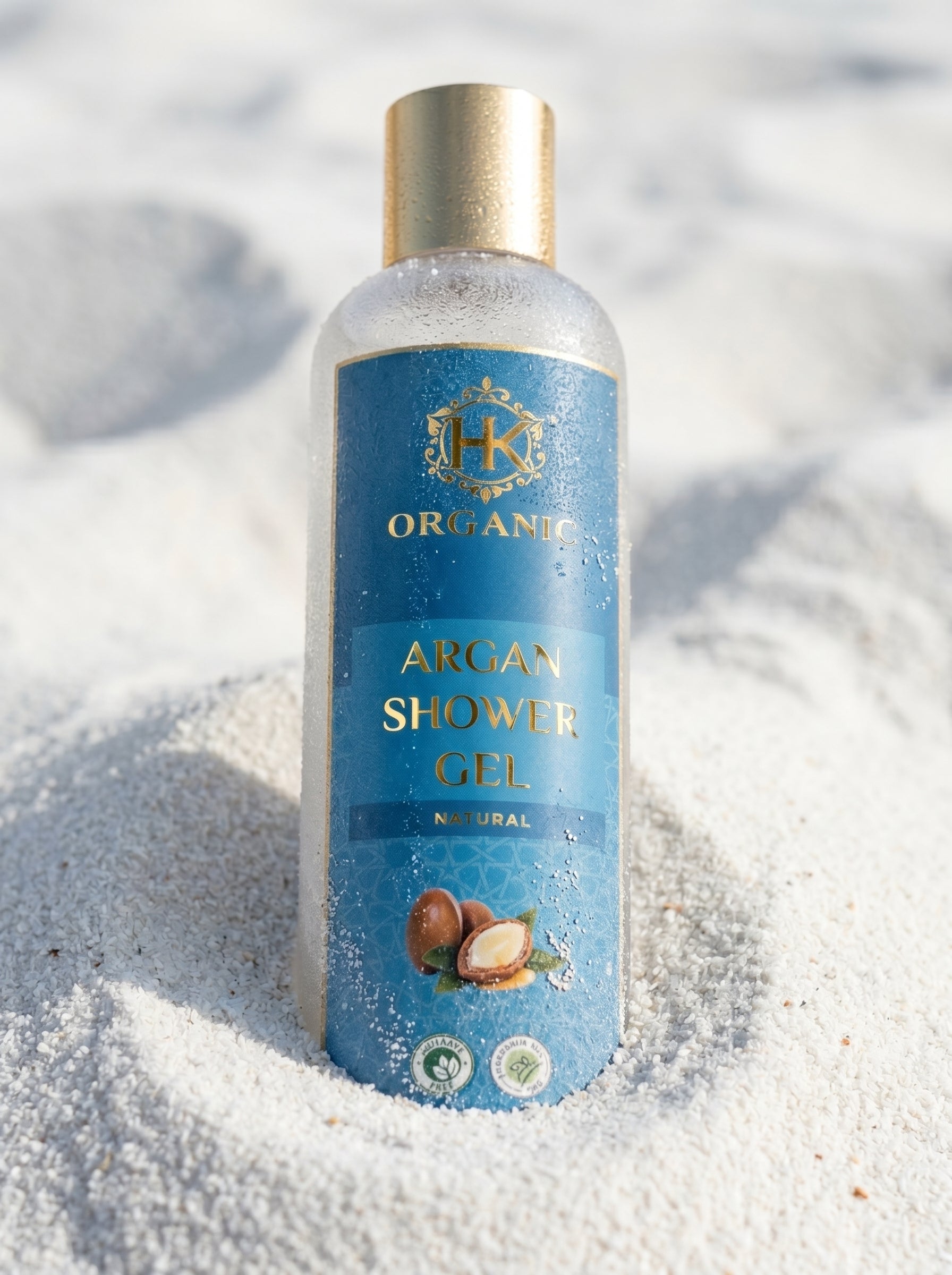 Bottle of organic argan shower gel on sand