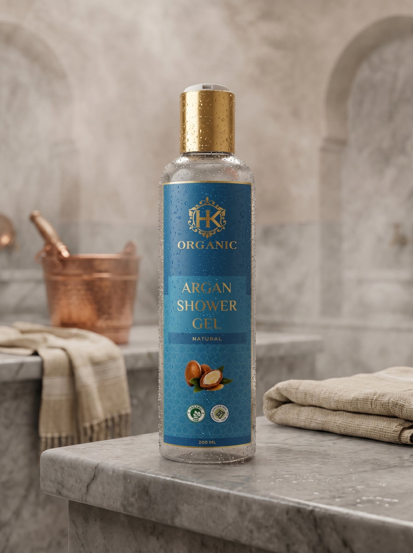 Bottle of organic argan shower gel on a marble surface with a bathroom background.