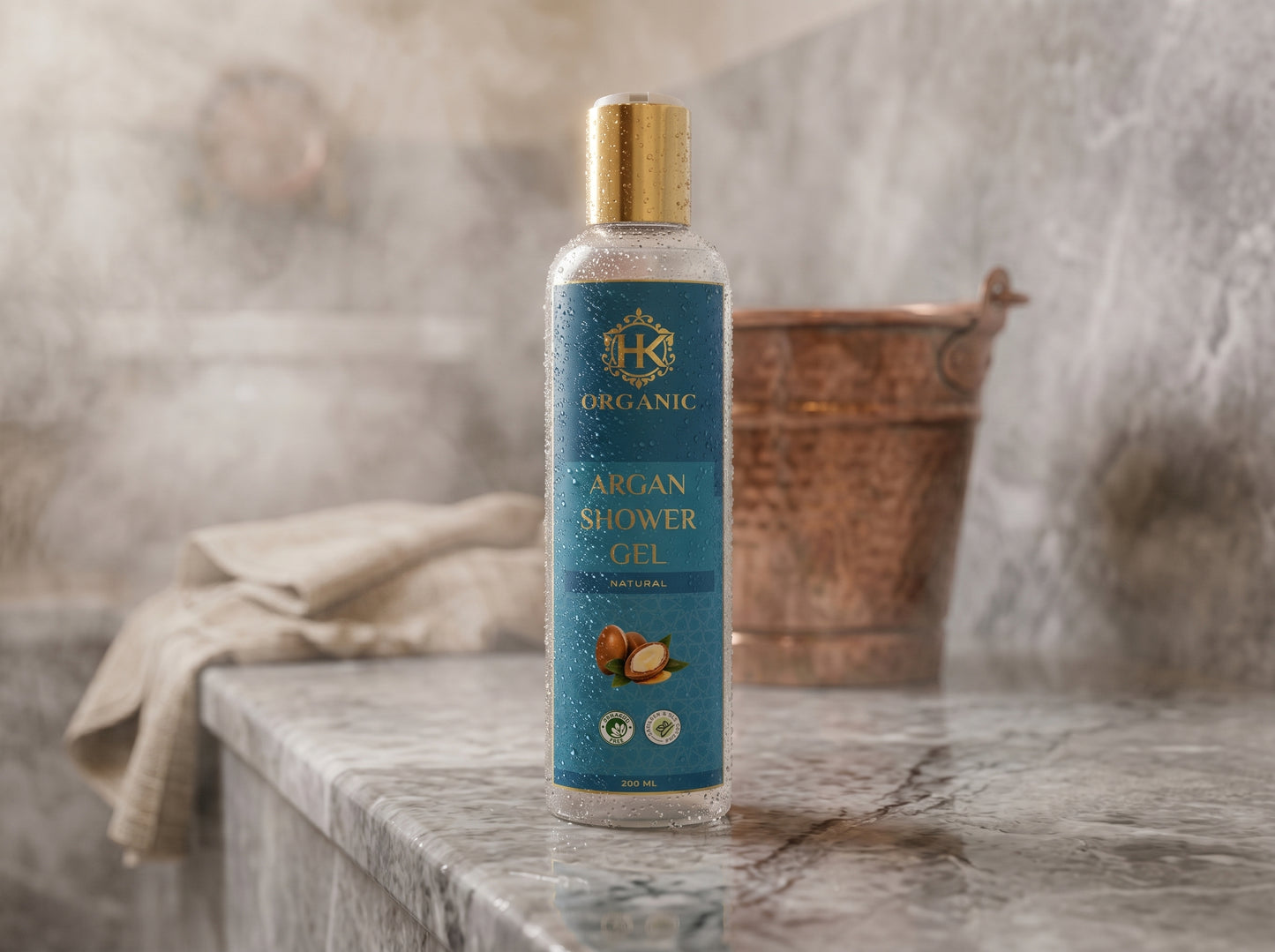 Bottle of organic argan shower gel on a marble surface with a blurred bathroom background