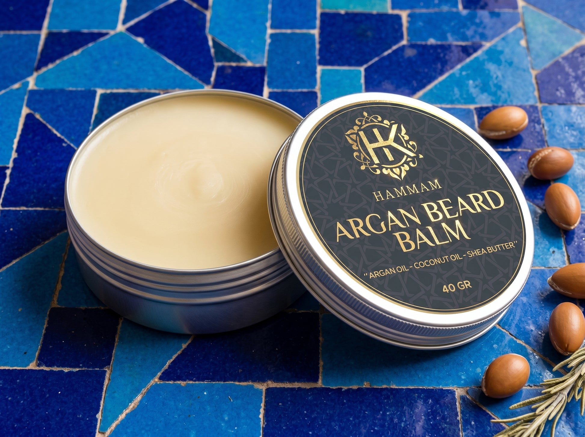 Hammam Argan Beard Balm container on a blue mosaic background with argan nuts.