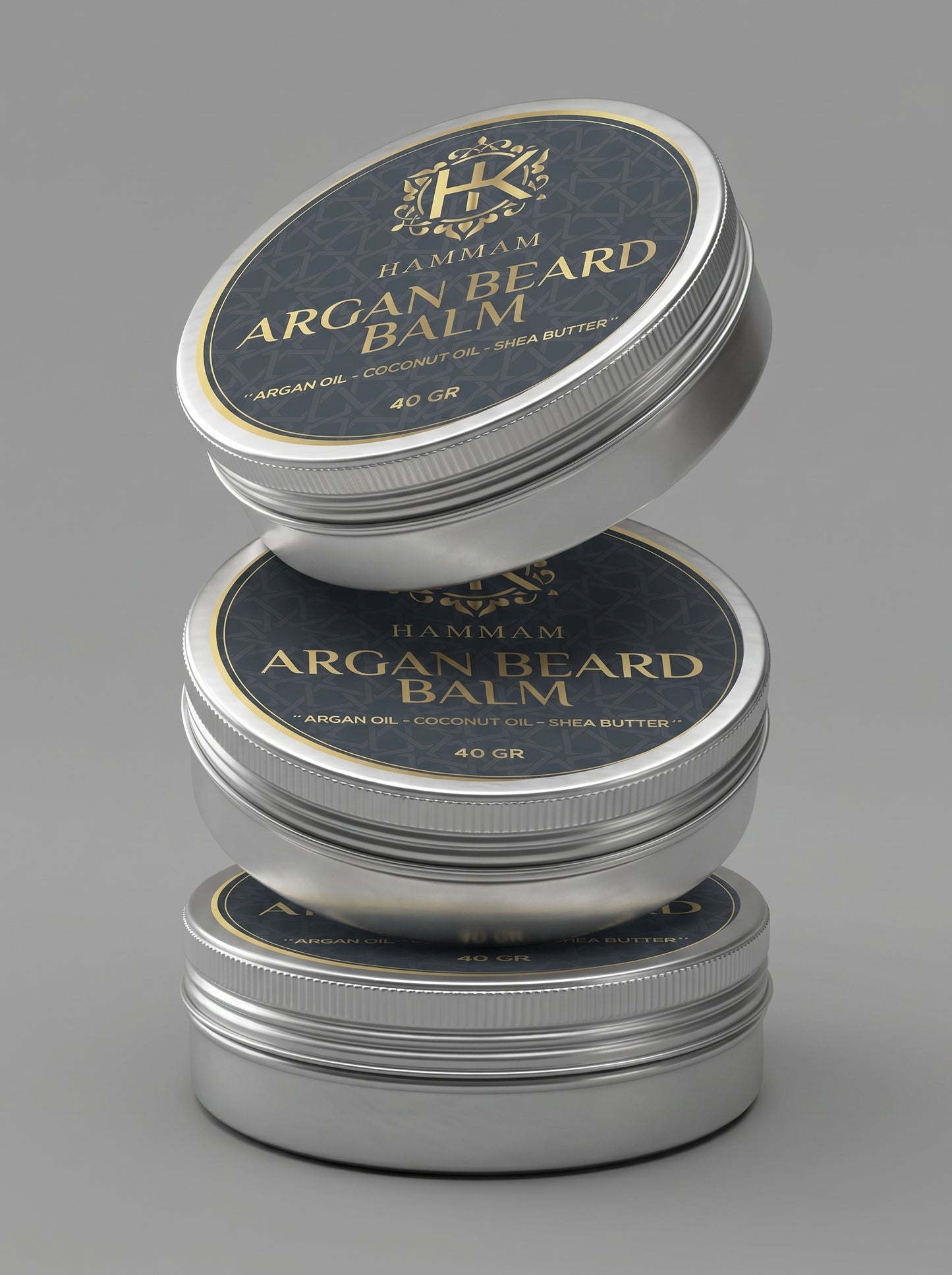 Three tins of Hammam Argan Beard Balm stacked on a gray background