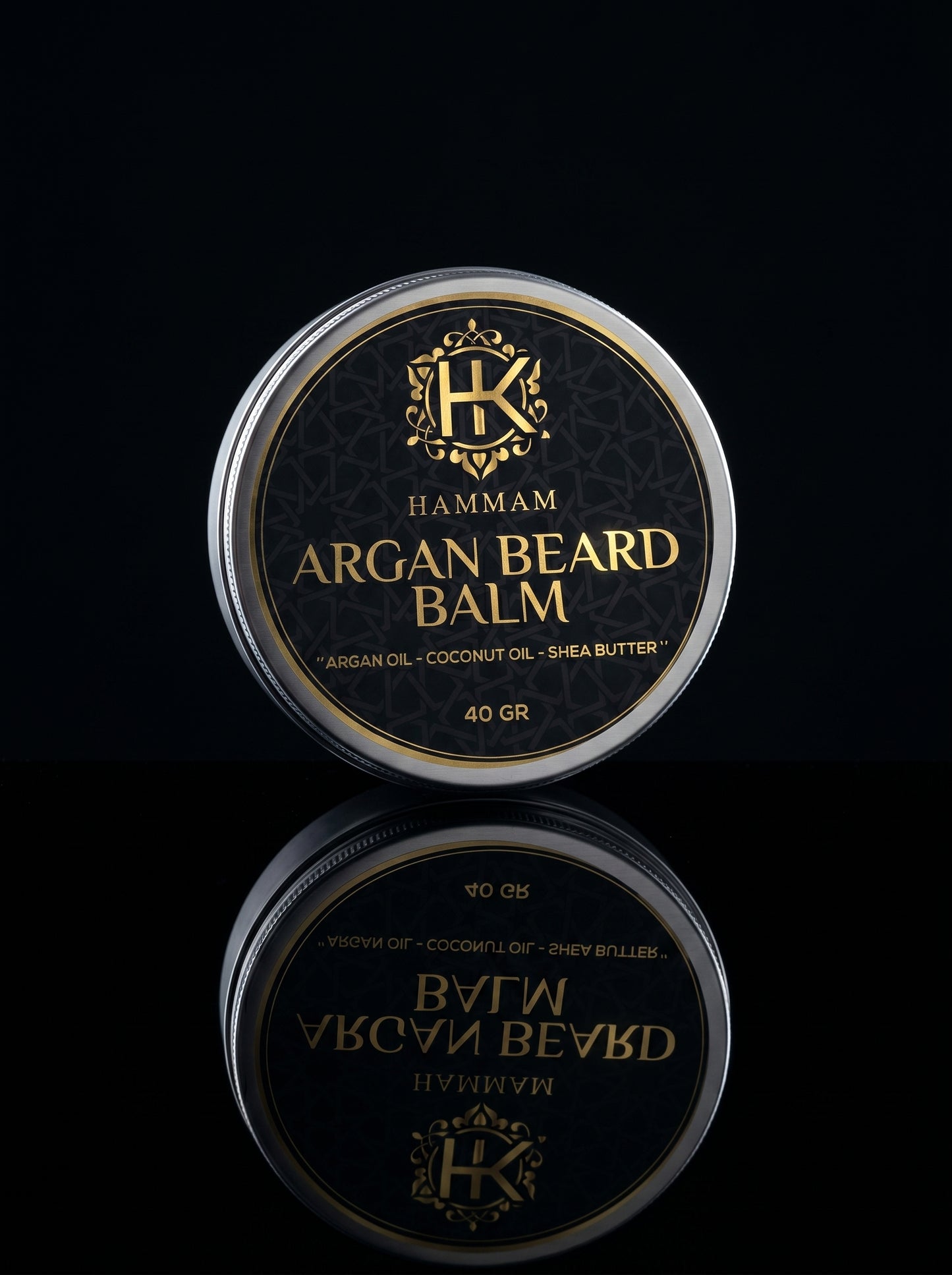 Hamam Argan Beard Balm container with reflective surface on a black background