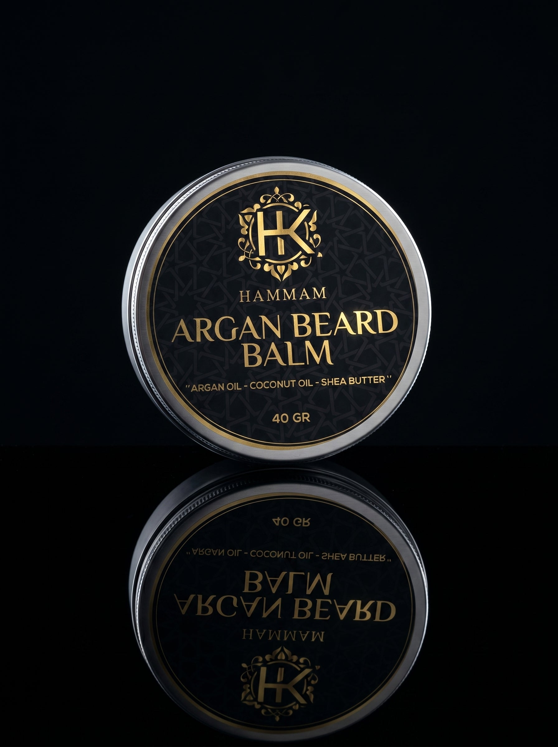 Hamam Argan Beard Balm container with reflective surface on a black background