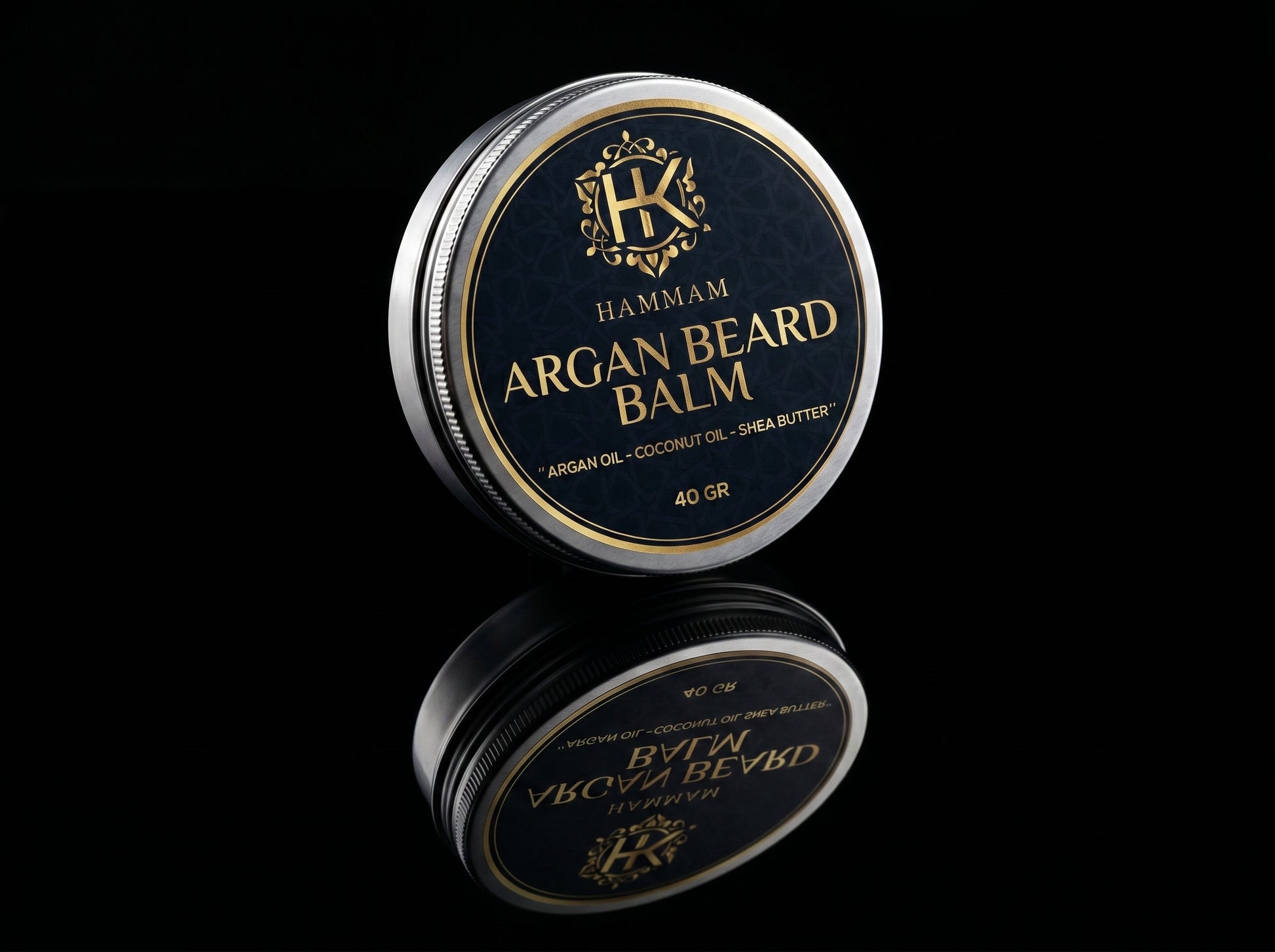 Hammam Argan Beard Balm container with reflective surface on a black background