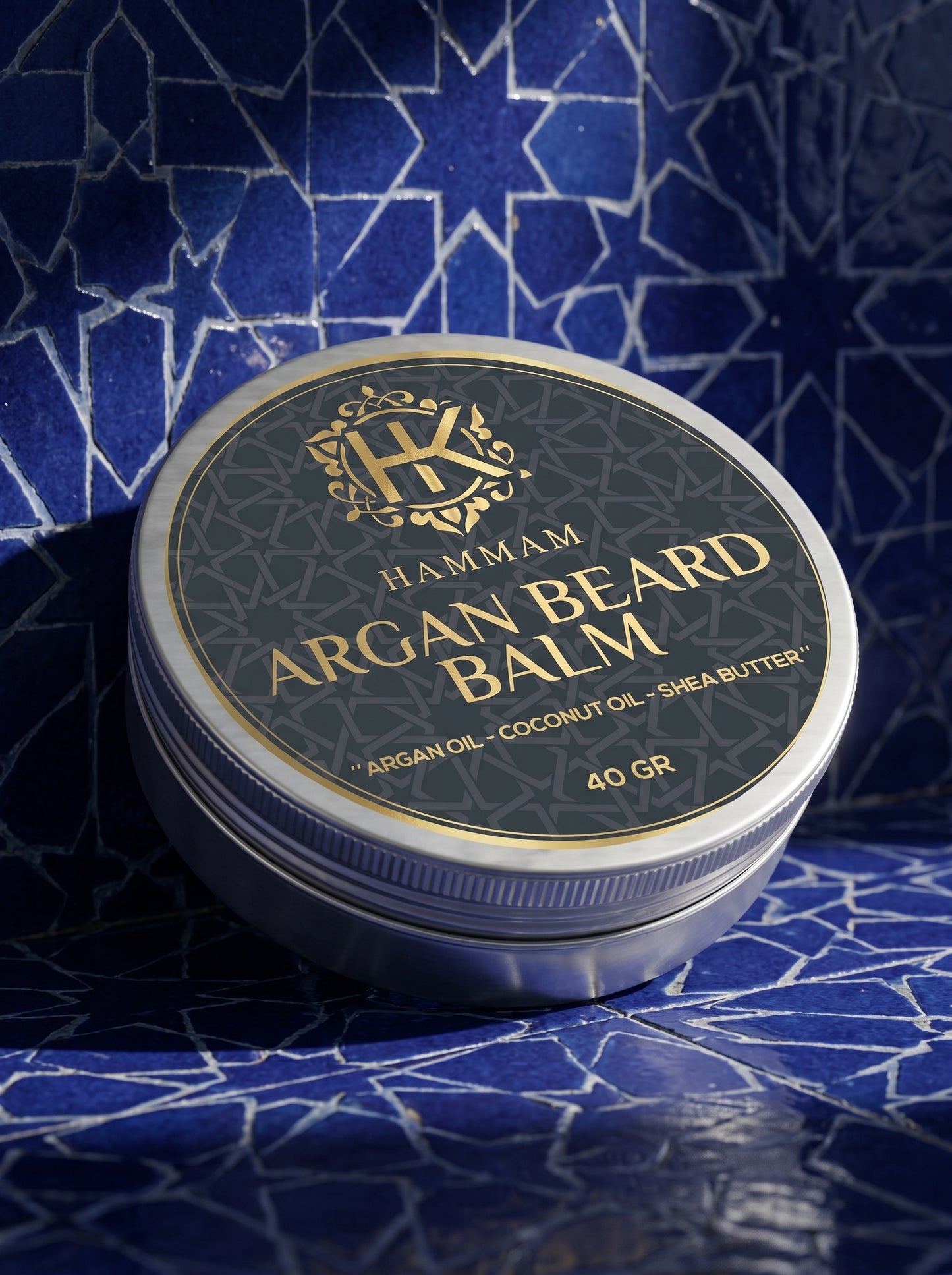 Hammam Argan Beard Balm container on a blue patterned background