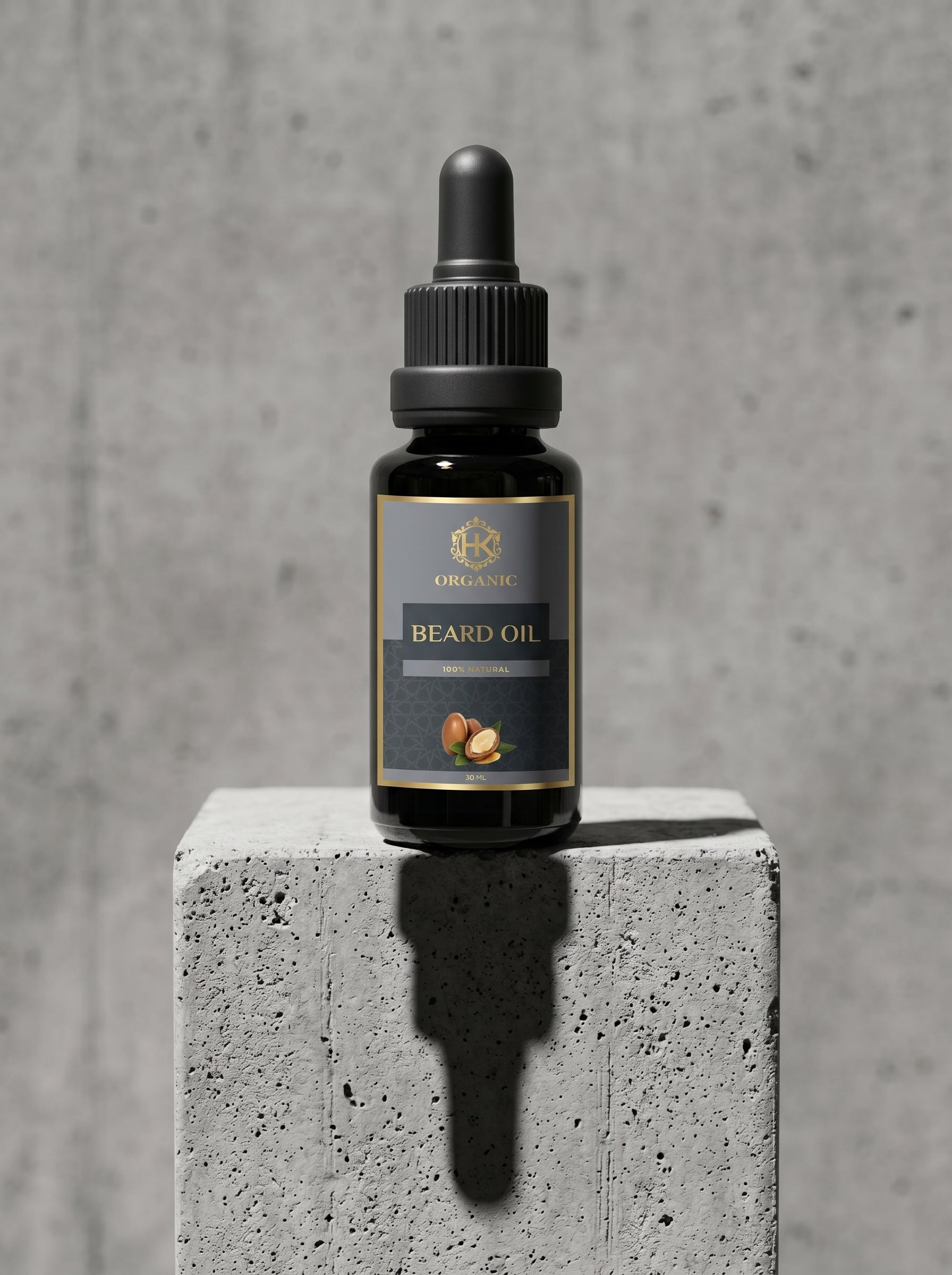 Bottle of beard oil on a concrete block with a gray background