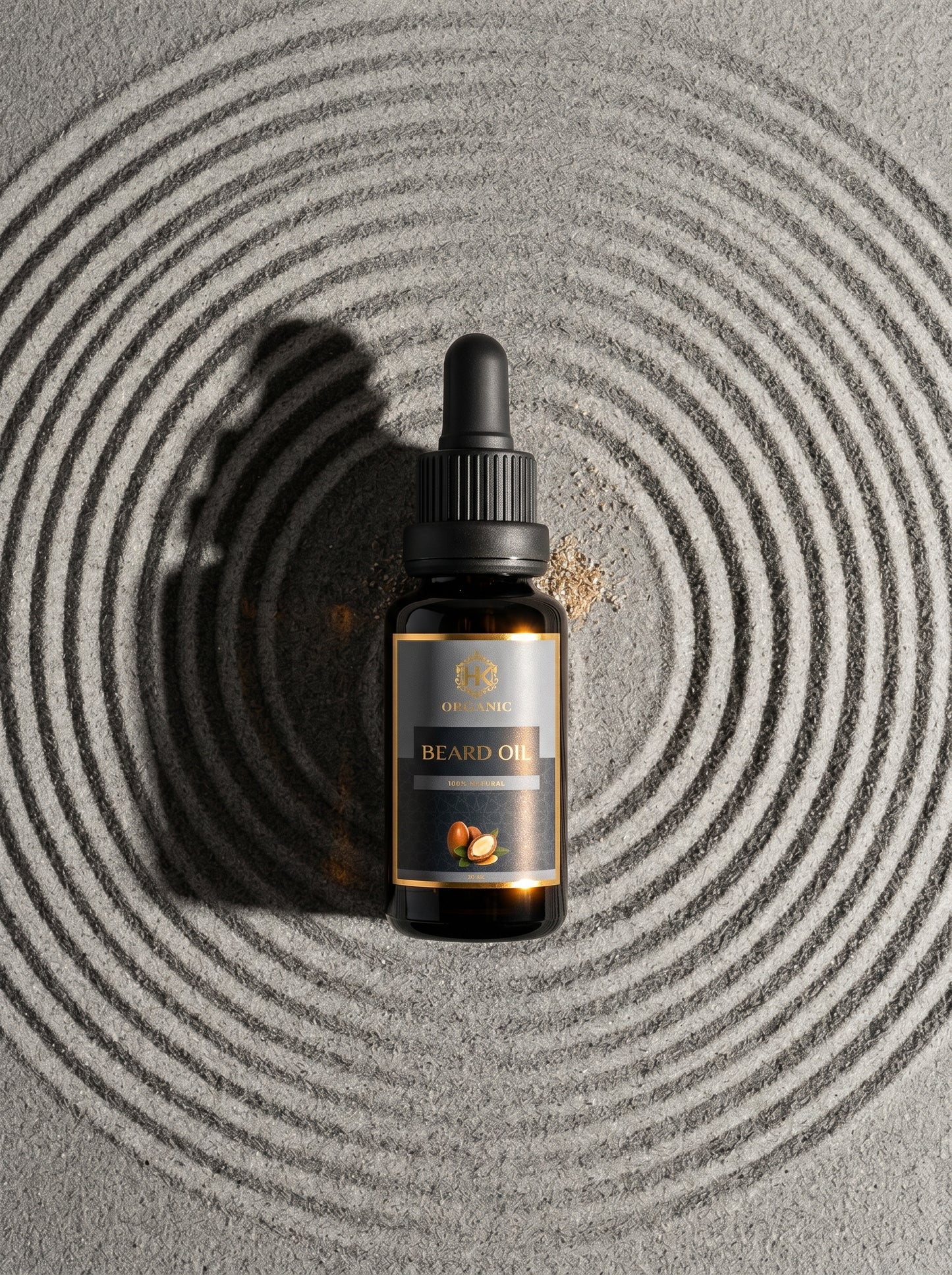 Beard oil dropper bottle on a textured gray surface