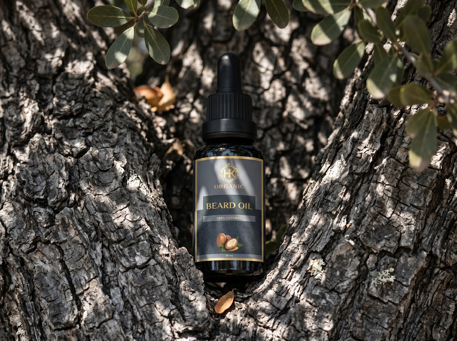 Bottle of beard oil on a tree trunk with leaves