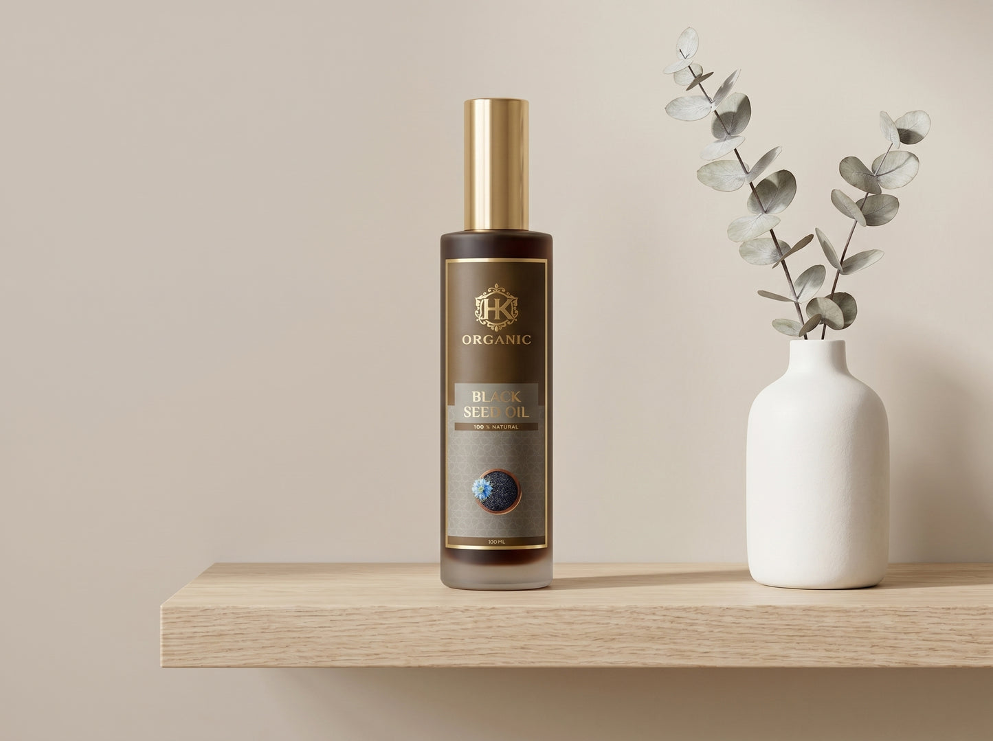 Bottle of organic olive oil on a wooden shelf with a vase of eucalyptus leaves.