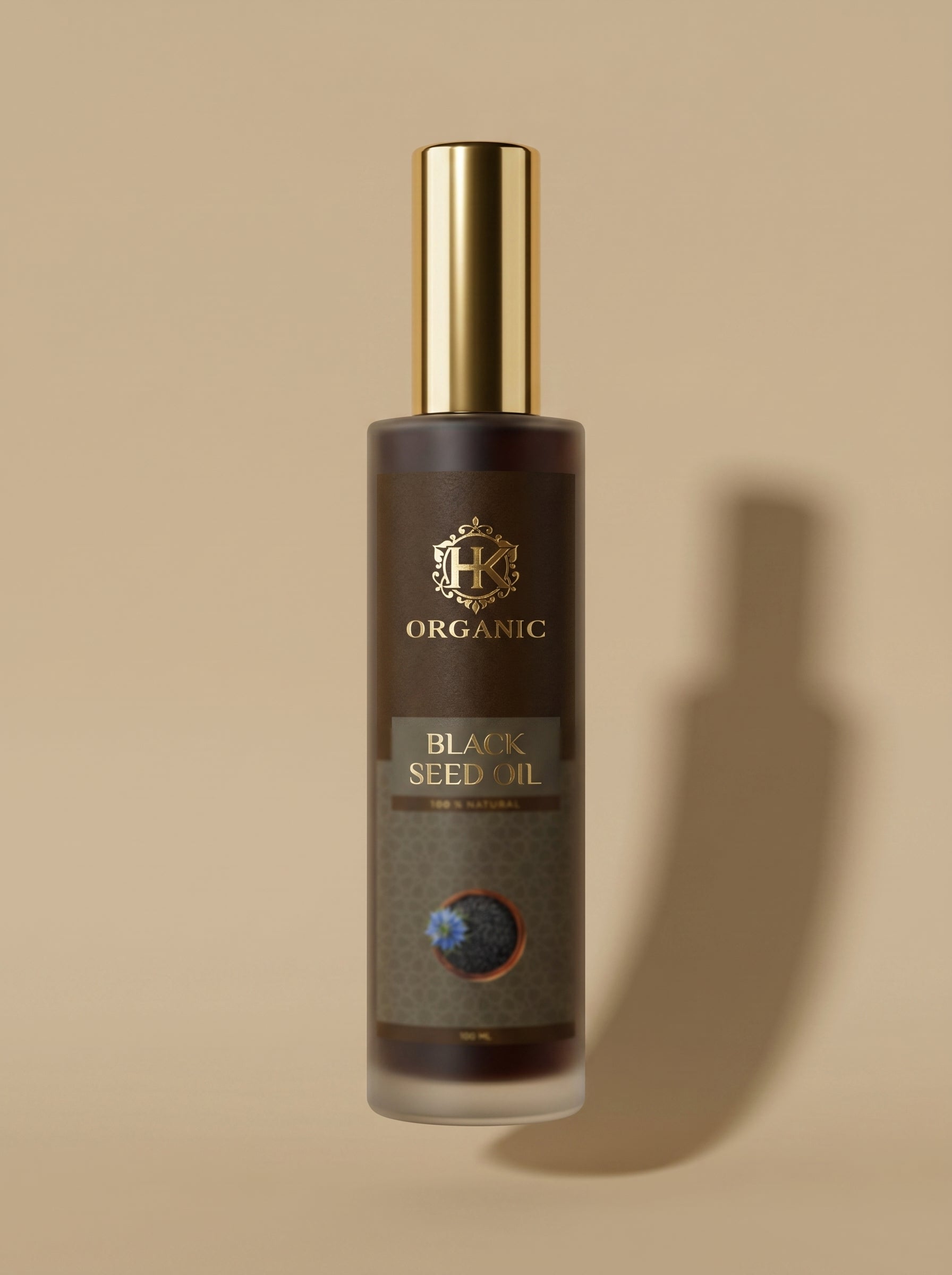 Bottle of organic black seed oil with a gold cap on a beige background