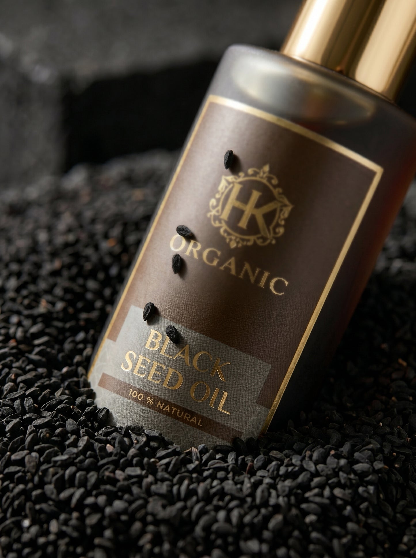 Black seed oil bottle with visible brand logo on a black background