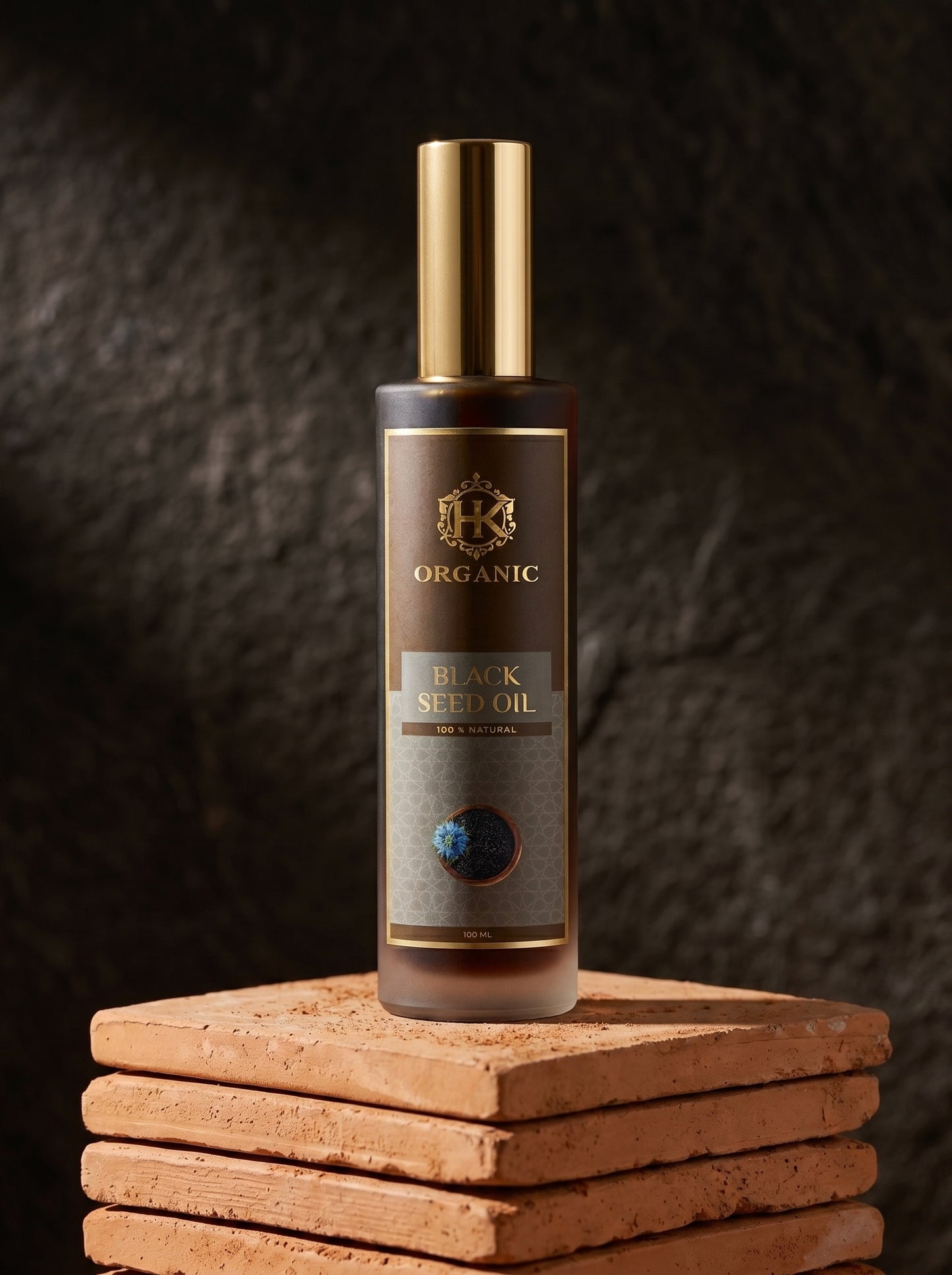 Bottle of organic black seed oil on a textured surface with a dark background