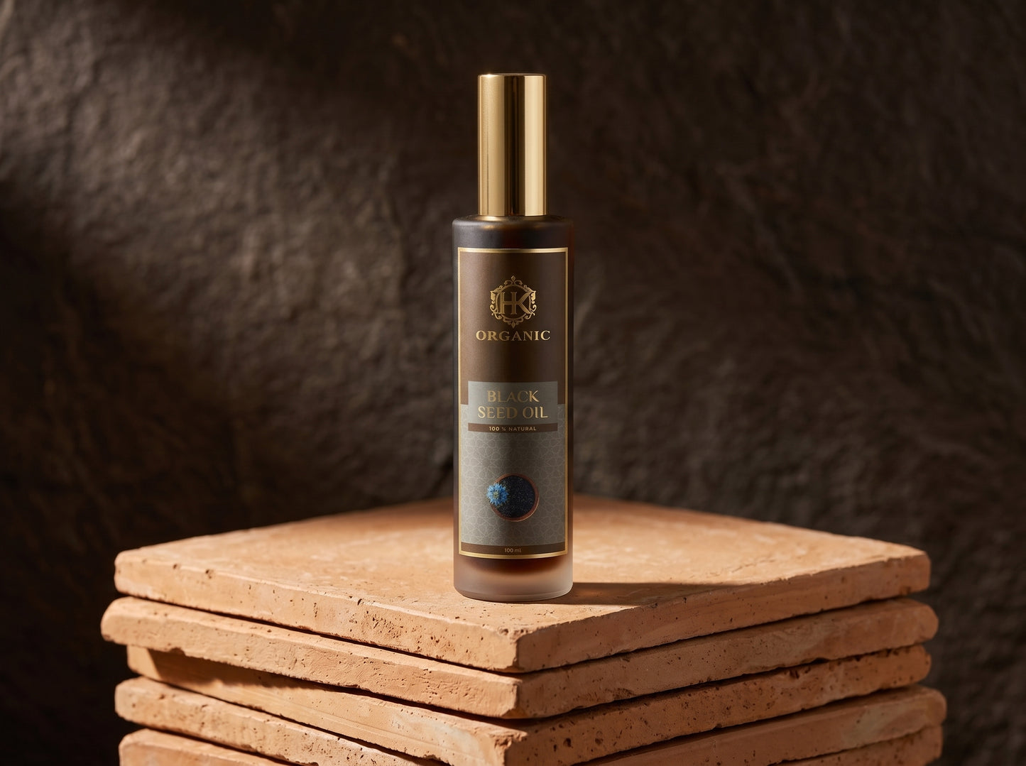 Skincare bottle with gold cap on a wooden block against a dark textured background