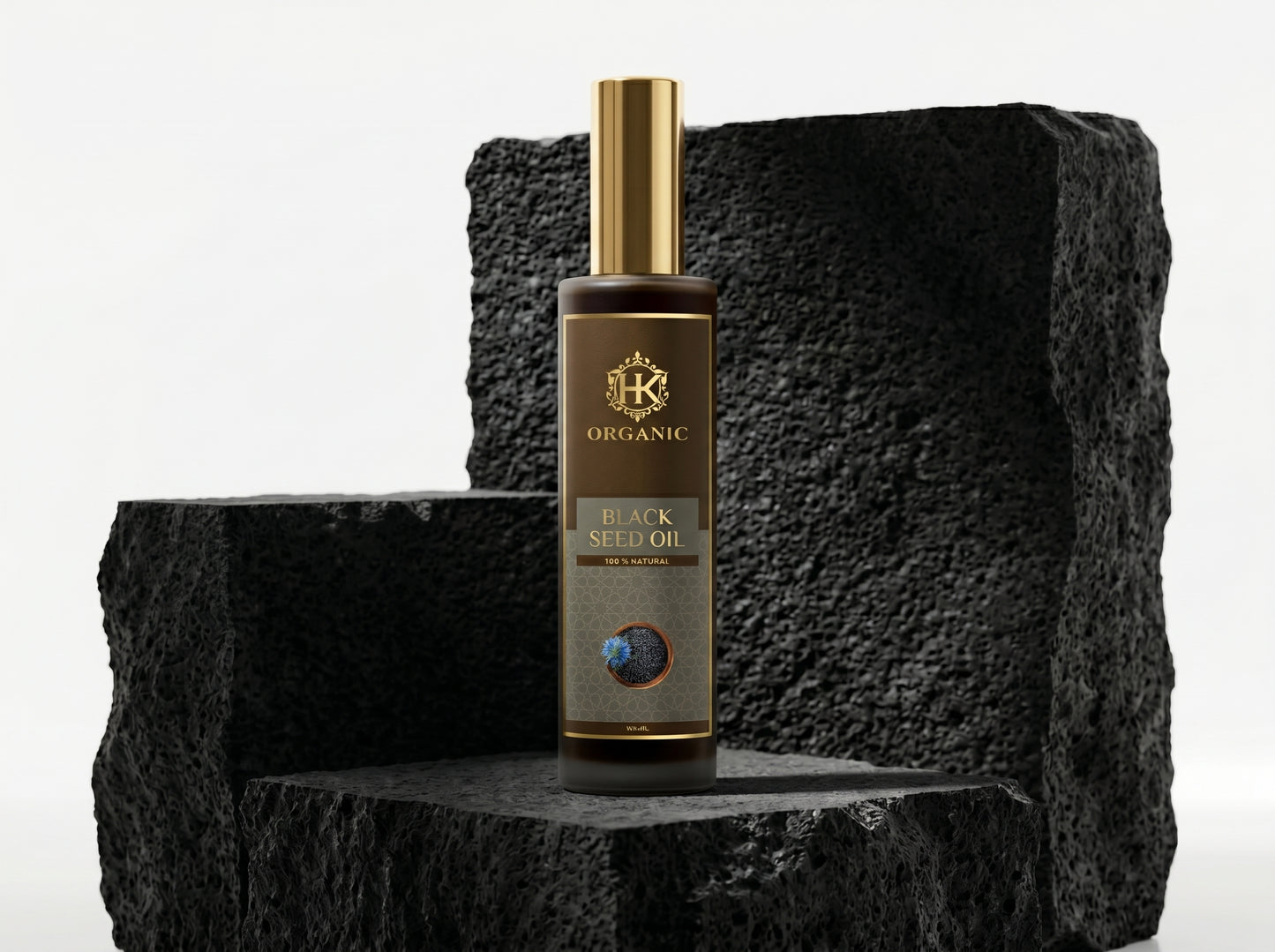 Bottle of organic black seed oil on a textured black surface with a white background