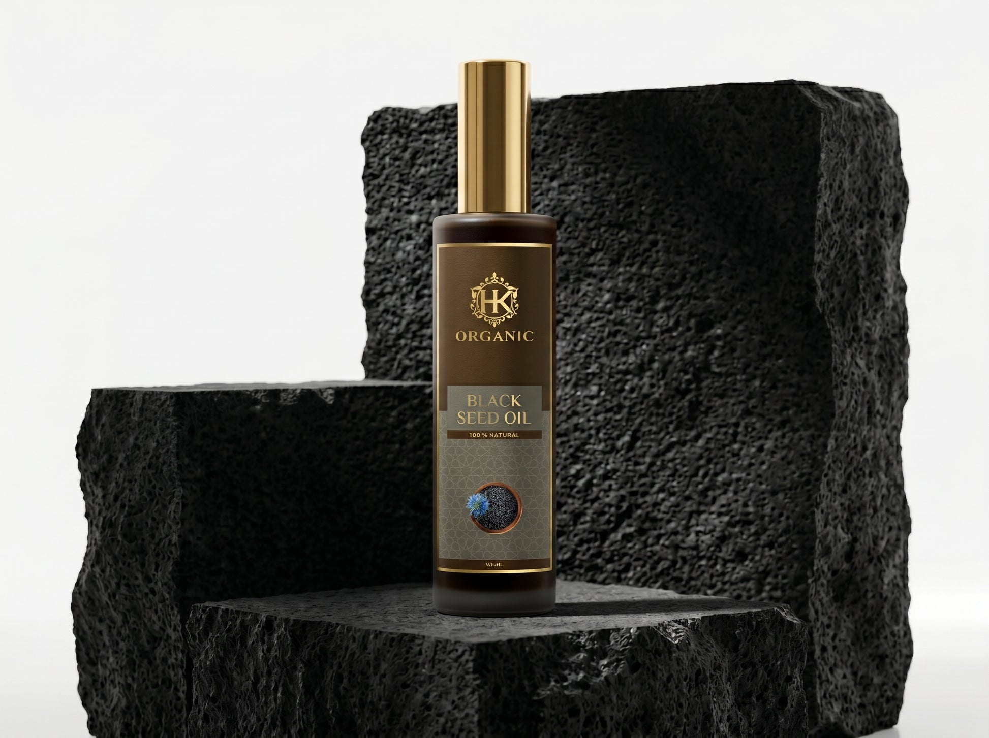 Bottle of organic black seed oil on a textured black surface with a white background