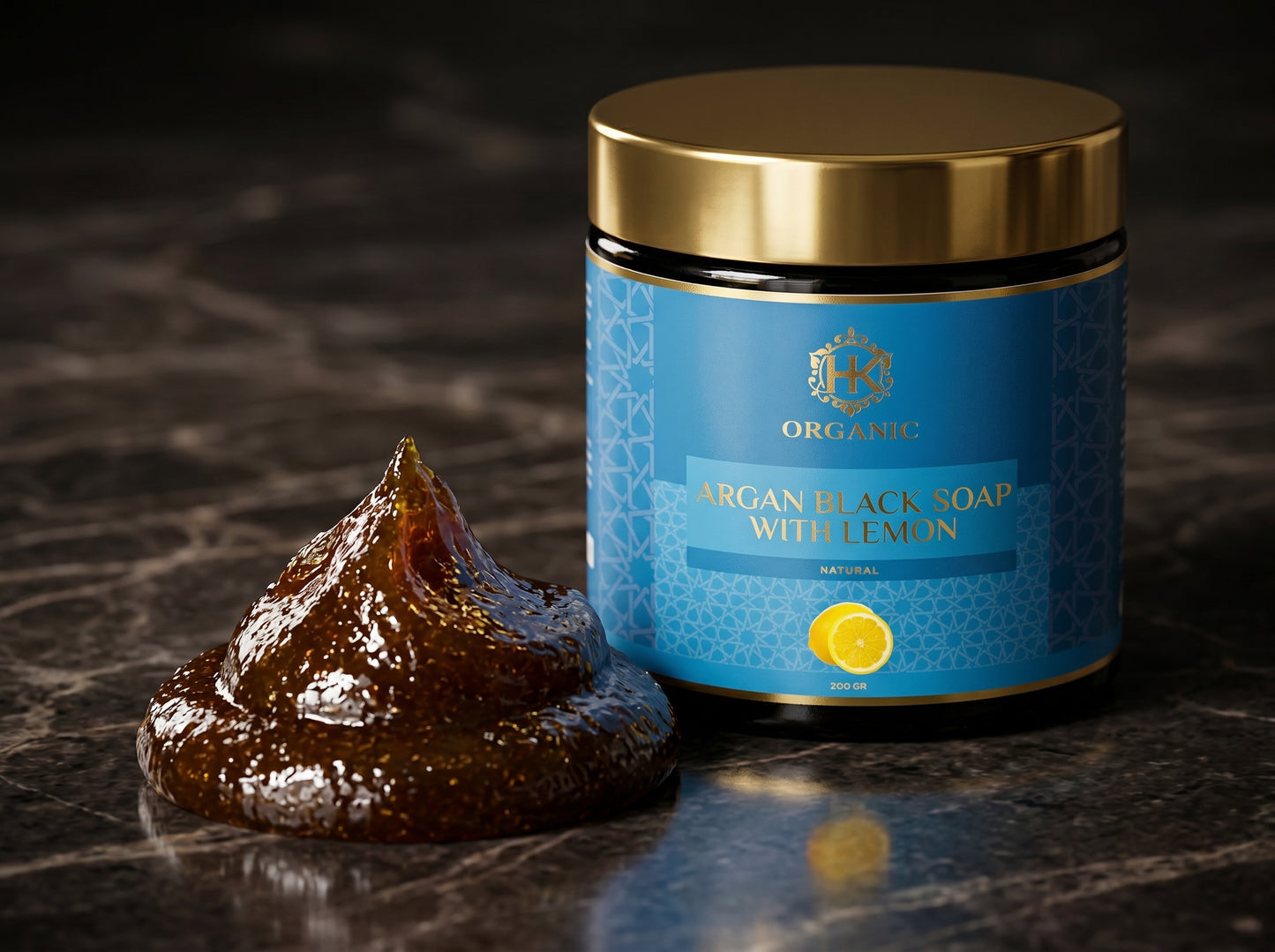 Blue jar of organic black soap with lemon next to a bar of soap on a dark surface