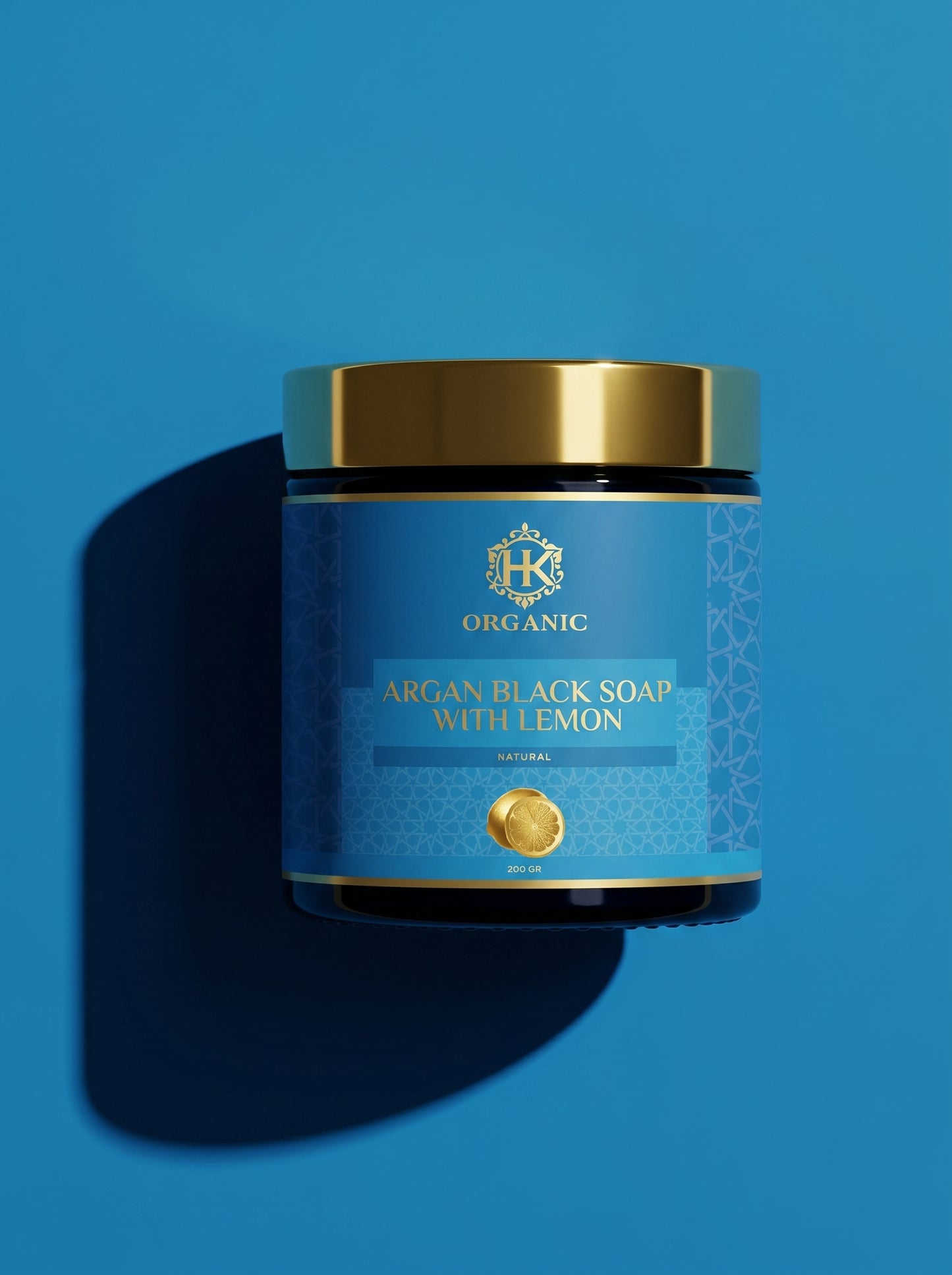 Jar of argan black soap with lemon on a blue background